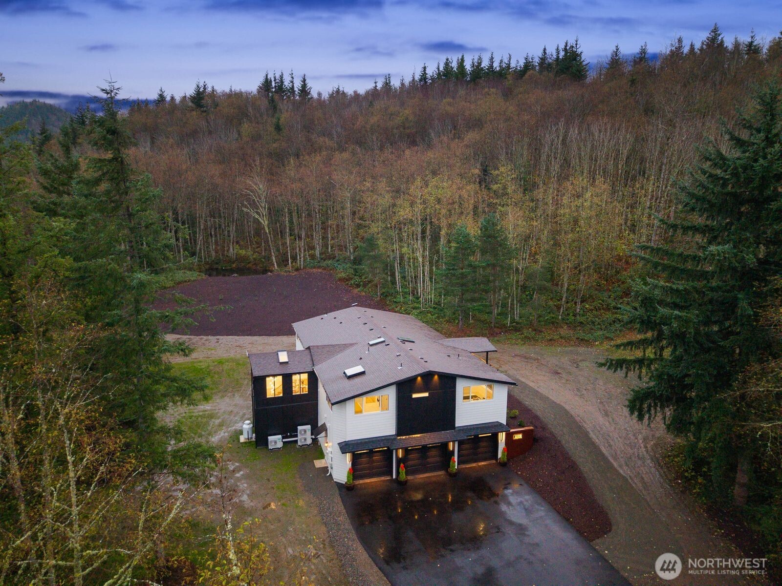 Experience unparalleled Northwest luxury on nearly 20 secluded acres in this exceptional custom-built home. Fully refreshed and spanning 4,820 sq ft, this estate blends modern sophistication with timeless craftsmanship, offering 4 bedrooms, 3.5 baths, and an expansive daylight lower level ideal for entertaining. A grand great room with vaulted ceilings opens to a chef’s kitchen with walk-in pantry and premium appliances. The main-level primary suite features a spa-inspired bath and generous walk-in closet. Outdoor living shines with a large deck, patio and finished / heated 1,000sq ft garage. Surrounded by rolling terrain and wooded beauty, this private retreat delivers unmatched comfort and style—just a quick drive to downtown Enumclaw.