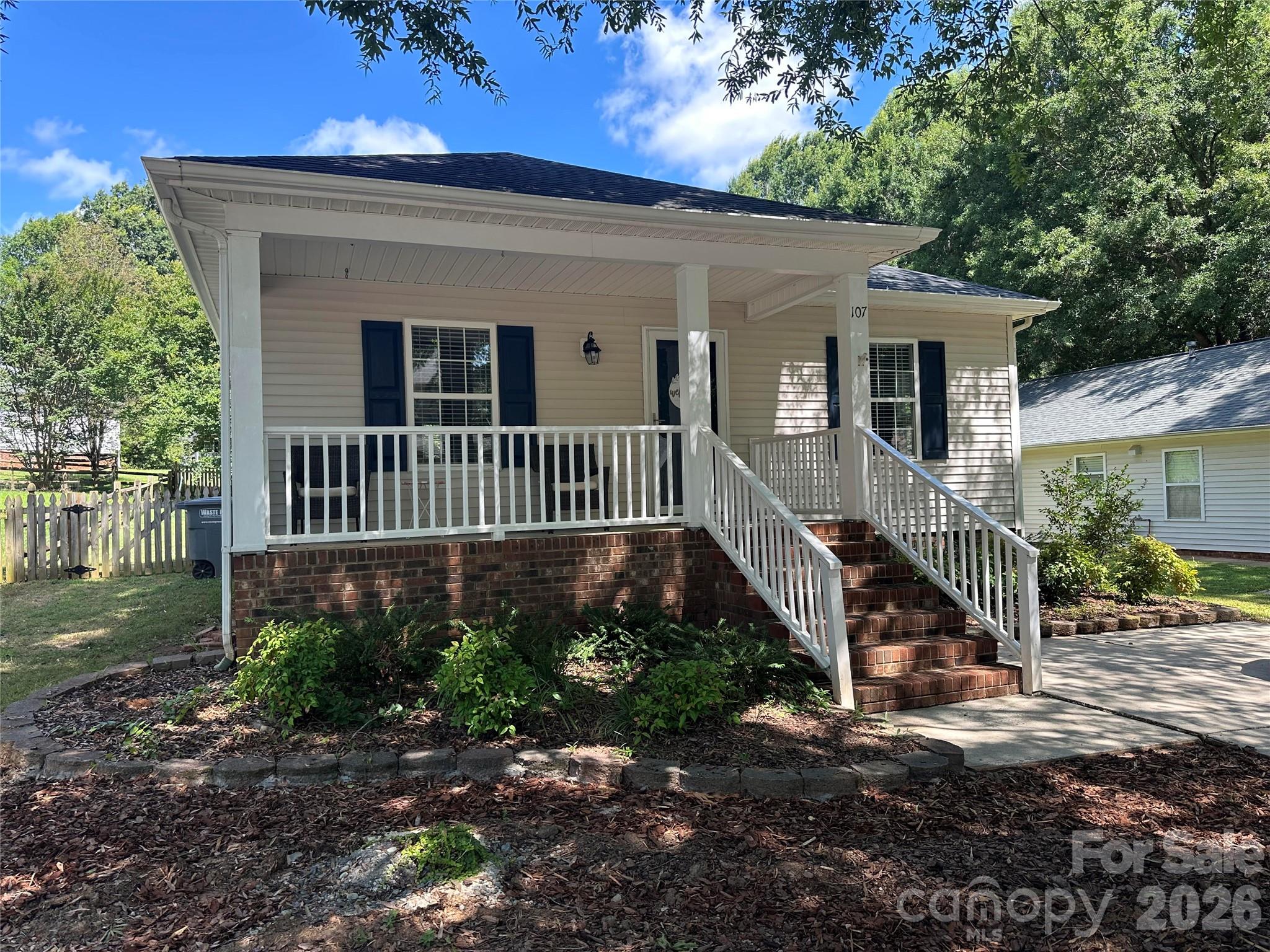 Welcome home to this beautifully updated 2-bedroom, 2-bath ranch nestled in the desirable Adams Bluff community! Offering over 1,000 square feet of thoughtfully designed living space, this move-in ready home combines comfort, style, and exceptional value just minutes from charming downtown Belmont.Step inside to durable laminate flooring throughout the whole home and a ton of natural light that creates a bright, inviting atmosphere. The kitchen features granite countertops, a tile backsplash, ample pantry space, and all appliances convey—including the refrigerator, washer, and dryer!One of this home's standout features is the fully paid-off solar panel system, providing outstanding energy efficiency. Even better, the system consistently generates more electricity than the home uses, resulting in a monthly credit from Duke Energy, helping reduce your utility costs while offering long-term savings.Enjoy your morning coffee on the welcoming covered front porch or unwind on the private rear deck overlooking the level backyard. Additional highlights include a concrete driveway with parking for two vehicles and a 30-year architectural shingle roof that was installed in 2019.Located just minutes from downtown Belmont's restaurants, breweries, parks, shopping, and easy access to I-85 and Charlotte, this home offers the perfect blend of small-town charm and everyday convenience.Move-in ready, energy-efficient, and full of value—don't miss your opportunity to own this Belmont gem with built-in monthly energy savings!