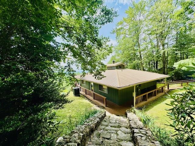 Cozy 2-Bedroom Mountain Cabin with Spectacular Piedmont Views Welcome to your dream mountain retreat, perfectly situated just off the scenic Blue Ridge Parkway in the peaceful community of Groundhog Mountain . This charming 2-bedroom, 1-bath cabin offers the ultimate in mountain living — with a wrap-around porch and expansive deck designed to capture the stunning, long-range views of the North Carolina Piedmont.  Inside, you'll find a bright, open floor plan that blends rustic charm with everyday comfort. The spacious living area features warm wood finishes and flows seamlessly into the kitchen and dining space — ideal for cozy evenings or entertaining with a view.  Step outside and you're greeted by the sights and sounds of nature. Whether you're sipping your morning coffee, enjoying the sunset, or watching local wildlife, the wrap-around porch and elevated deck provide the perfect vantage point.  Additional highlights include:  Quiet seclusion, nestled in trees with a beautiful stone walkway leading toward a garden area near the street.   Detached workshop or storage space.  Abundant natural light and scenic views from nearly every room.  Easy access to hiking, Blue Ridge Parkway attractions, and nearby Mount Airy NC.   Whether you're looking for a full-time residence, weekend escape, or a vacation rental opportunity, this mountain gem offers peace, privacy, and panoramic beauty.