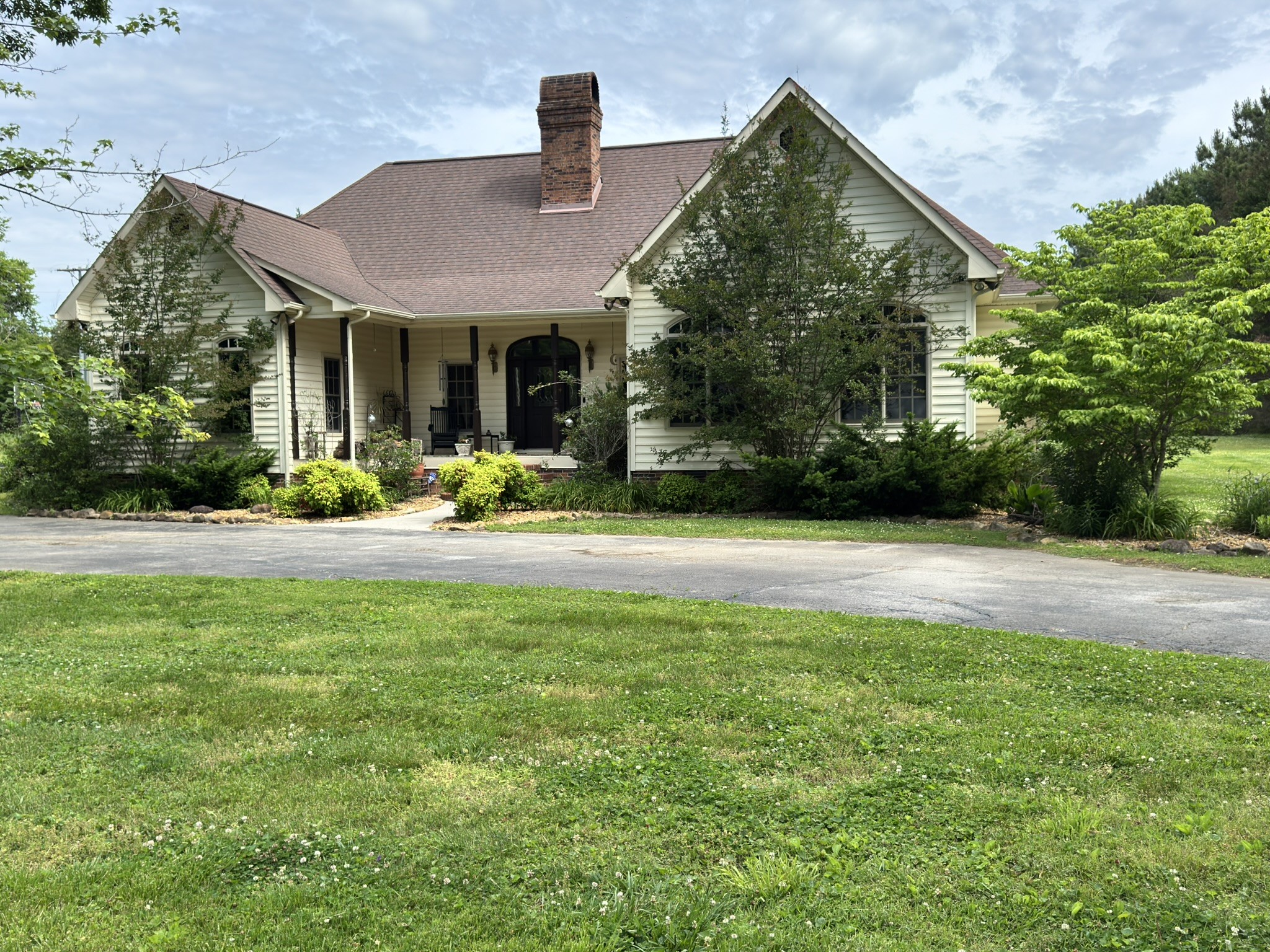 This impressive 3,100 sq ft two story home offers exceptional space, comfort, and versatility with 5 bedrooms and 3 full bathrooms, including a main level primary suite and 10 ft ceilings throughout the downstairs living areas.The inviting living room features a wood burning fireplace with an electric insert, creating a warm focal point for gatherings. Just off the living room, a built in wet bar enhances the home’s entertainment appeal. A formal dining room with a chandelier and classic parquet flooring adds charm and elegance. The spacious kitchen provides abundant cabinet and workspace, showcasing custom cherry cabinetry, a walk in pantry, and a JennAir stove with grill—perfect for home chefs who value both function and style. The primary suite on the main level offers a relaxing retreat with an ensuite bath featuring a jetted tub. Two additional downstairs bedrooms provide flexibility for guests, office space, or multigenerational living. Convenient hall and foyer closets offer excellent storage on the main floor. Upstairs, you’ll find two large bedrooms, including one with its own ensuite bath. Both bedrooms feature oversized closets, and the upper level is enhanced by skylights that fill the space with natural light. A flex room and eave storage add even more functionality. Step outside to your private oasis—a 20x44  inground heated saltwater pool with a slide and a beautifully designed pool deck, perfect for summer fun, entertaining, or simply unwinding in your own backyard retreat. Property comes with and additional lot for a total 2.5 +/-Acres. Home is selling AS-IS but seller is offering a 1 year warranty.