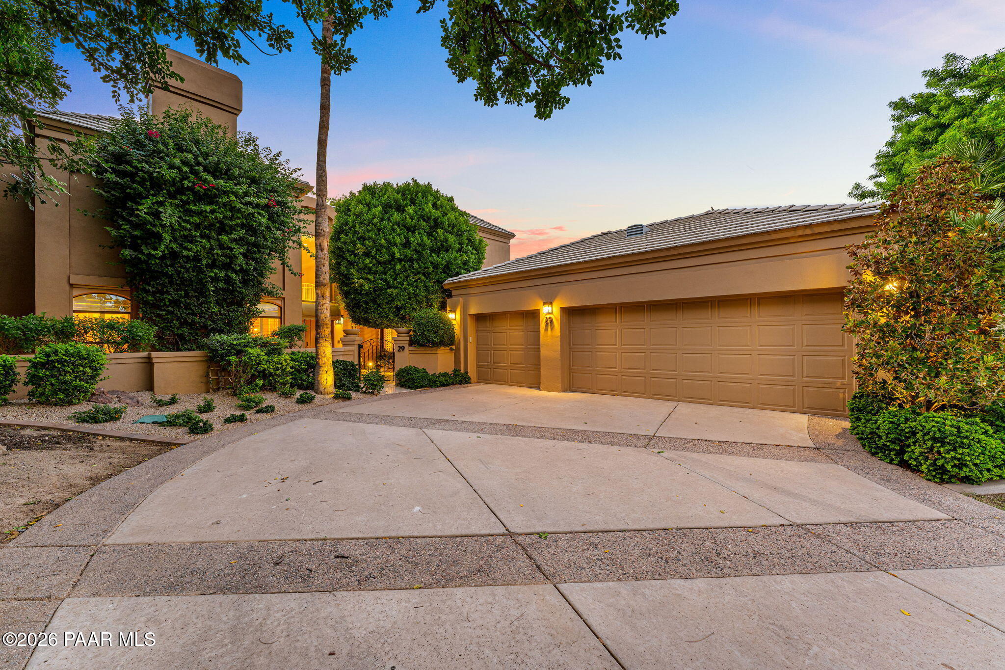 Experience refined Scottsdale living in this exceptional golf course residence located within the prestigious gated community of Gainey Ranch. Offering 4,488 square feet of beautifully appointed living space, this impressive 3-bedroom, 4.5-bath home combines grand architectural details, sophisticated finishes, and spectacular golf course views with an exceptional layout designed for both elegant entertaining and everyday comfort. Step inside to soaring ceilings, dramatic arched accents, crown molding, luxury tile flooring, plush white carpeting, glamorous chandeliers, plantation shutters, and expansive windows that fill the home with natural light while showcasing the picturesque golf course setting. Two spacious living and family areas provide incredible flexibility, complemented by a formal dining room, breakfast room, wet bar with sink and ice maker, and three striking fireplaces featuring floor-to-ceiling tile surrounds. Multiple sliding glass doors create a seamless connection to the patios and outdoor living spaces.The beautifully equipped kitchen is designed for those who appreciate both luxury and function, featuring granite countertops with a matching granite backsplash, abundant cabinetry, a walk-in pantry, built-in refrigerator, induction cooktop, stainless steel double wall ovens, dishwasher, trash compactor, and even a built-in toaster.The expansive primary suite is a true private retreat, complete with its own fireplace, private balcony overlooking the surroundings, and two walk-in closets. The luxurious primary bath offers a dramatic jetted soaking tub, oversized walk-in shower, separate vanities, and private water closet. Guest bedrooms provide exceptional privacy with their own full bathrooms and walk-in closets, while one also enjoys a private balcony. One guest bedroom is currently being used as a closet with shelving and an island. A showstopping wood-paneled office adds another level of distinction with rich built-ins, a beamed ceiling, fireplace, walk-in closet, and private full bathroom-creating an impressive executive workspace or flexible additional retreat. A spacious laundry room with granite countertops and utility sink provides additional functionality, while the 3-car garage features tile flooring, built-in cabinetry, and an additional refrigerator.Outside, the property takes full advantage of its coveted golf course location. Beautifully landscaped grounds feature mature trees, abundant flowering shrubs, tiled patios and walkways, and a welcoming fountain at the front entrance. The backyard is designed for year-round Scottsdale living with a built-in outdoor kitchen featuring a grill and granite countertops, two outdoor fireplaces, heated spool, water feature, privacy walls, and mechanical privacy shutters.With breathtaking golf course views, multiple balconies and outdoor entertaining spaces, exceptional privacy, and an elegant interior filled with custom details, this remarkable Gainey Ranch residence offers an extraordinary opportunity to enjoy luxury living in one of Scottsdale's most desirable gated communities.