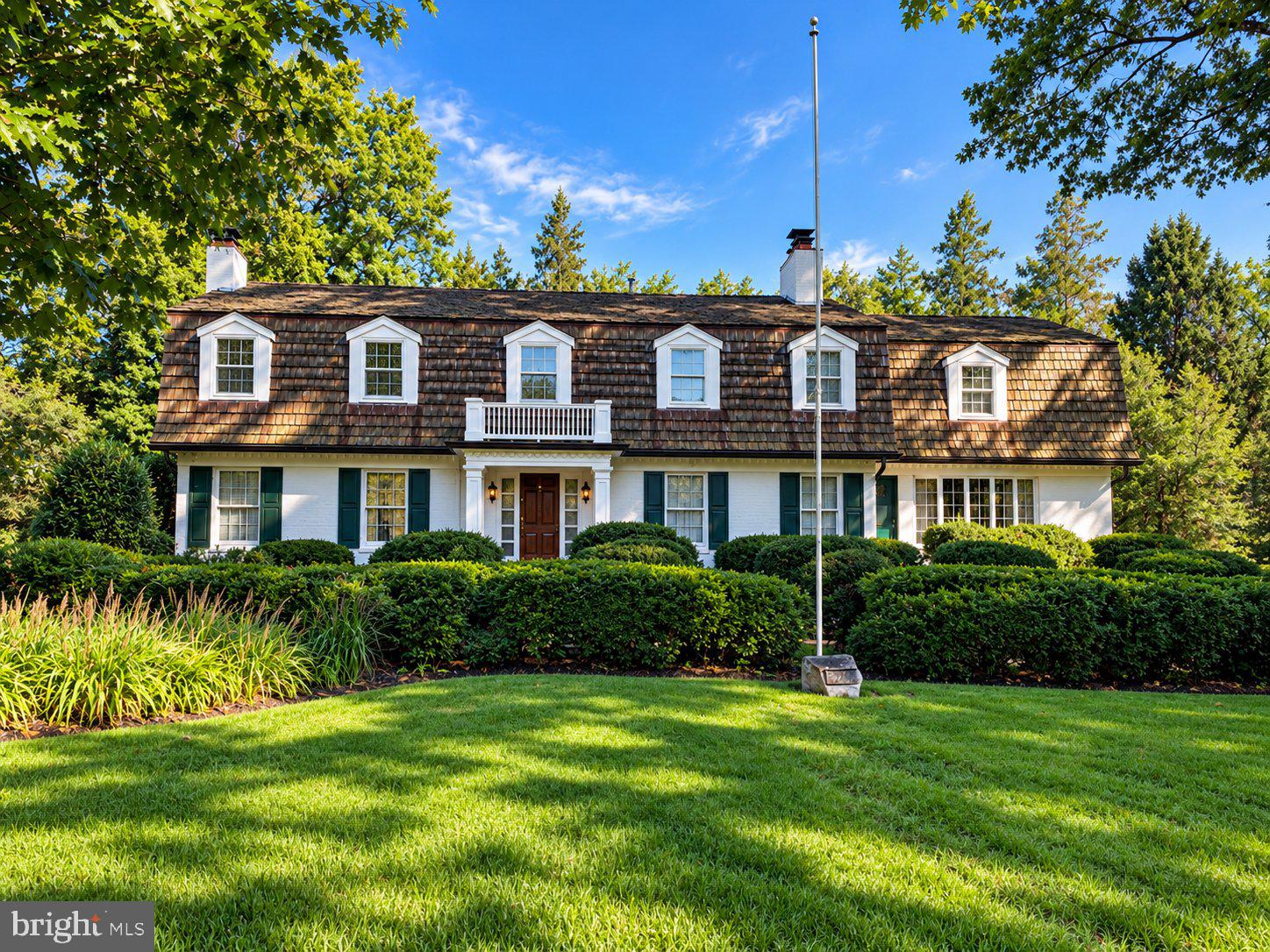 Rare North Arlington estate on approx. 2 private acres, including a separately platted, buildable adjoining lot, with the option to build, invest, or preserve the privacy of the grounds. Built in 1968, this 6-bedroom, 5.5-bath home pairs classic character with a scale and privacy seldom found this close in. Hardwood floors throughout and multiple fireplaces set a warm tone. Living room with fireplace, formal dining room, and a large kitchen with generous island and pantry. Also a study with built-ins and a TV room with a massive fireplace. The walkout lower level features a rec room with bar and fireplace. The primary suite has its own fireplace, and six bedrooms offer flexibility for guests, offices, or multigenerational living. A 4-car garage adds rare parking and storage. Outside, a slate patio with pergola and outdoor fireplace overlooks expansive lawns. A remarkable combination of character, space, and private acreage in North Arlington.