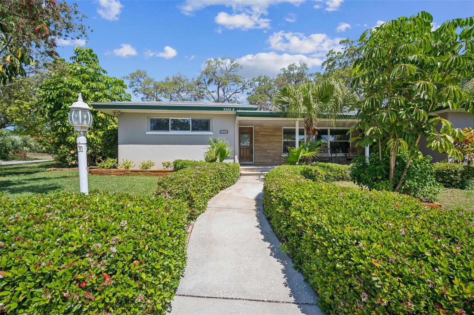 Impressive 4-Bedroom, 3-Bathroom Home in Del Oro Groves Estates! Located in a prime neighborhood in Clearwater, Pinellas County, this spacious single-family home offers comfort and style. With 4 generously sized bedrooms and 3 full baths, so there’s room for the entire family. The oversized 2+car garage provides extra storage and workspace with a built-in workbench. Enjoy the outdoors with a screened-in pool and lanai, perfect for relaxation and entertaining, complete with stone pavers. The kidney-shaped pool, recently resurfaced with a PebbleTec finish, adds an elegant touch to the outdoor area. The built-in bar with sink and BBQ/cooking area with chimney make this backyard an entertainer’s dream. This home features a brand-new roof in 2025, and its masonry exterior (stucco/brick) was freshly repainted just 6 months ago. The covered front porch with stone pavers welcomes you, while a circular driveway and side driveway to the garage provide ample parking. The kitchen and dining area boast a large walk-in pantry, abundant cabinets, and a convenient laundry room located between the garage and kitchen. The large corner lot provides plenty of space and privacy, and the fenced-in parking spot is ideal for an RV or boat. Additional features include a lawn well/pump irrigation system with access to reclaimed water, removable hurricane shutters, and a portable generator for peace of mind during storm season. The home is in a non-evacuation and no-flood zone and has never been damaged or flooded by storms. This deed-restricted community of 330 homes offers a neighborhood watch and optional dues of just $25 per year. Conveniently located, with major box stores within 3 miles, and an easy commute to Tampa, St. Petersburg, Clearwater, and Safety Harbor. Enjoy quick access to the Pinellas/Ream Wilson Trail, and only 400 feet to Cooper’s Bayou for kayaking or exploring Tampa Bay.