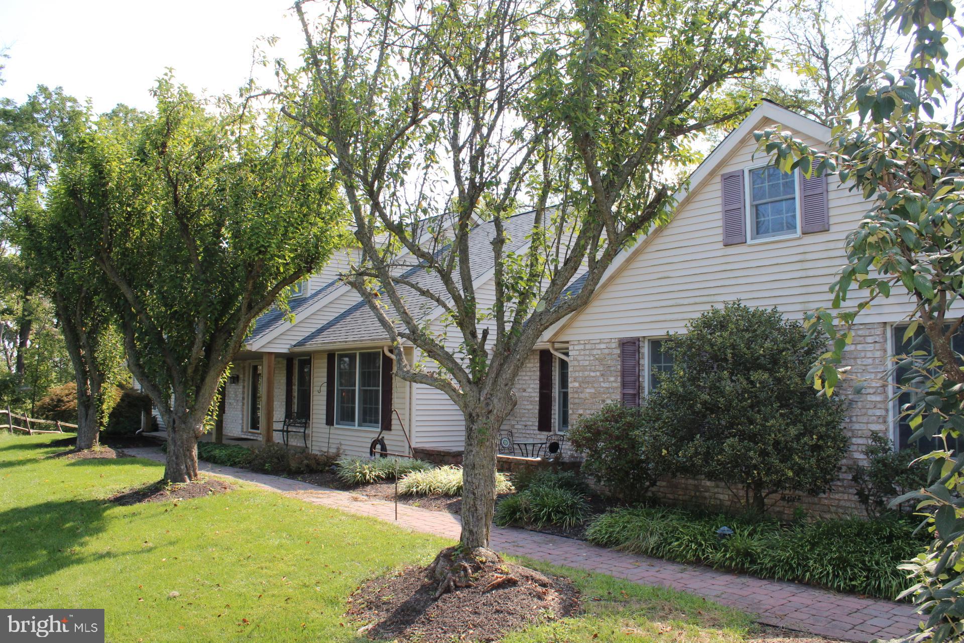 Wonderful custom home, secluded but just minutes from Boyertown, nestled on 14.05-acre parcel w/wooded & open areas offering cut hiking trails, come walk the trails and enjoy nature or hunt and never leave your property.  At just over 3,100 hundred square ft this home offers four spacious bedrooms, 3.5 bathrooms and a first-floor master bedroom.  Entering the home, you'll be greeted the naturally flowing floor plan and beautiful hardwood flooring that flow directly to the great room w/full wall natural wood burning brick fireplace. The great room is basked in natural light by double sliders providing access to screened patio entertaining and outdoor dining area. Spacious eat-in kitchen w/solid Oak cabinetry, Corian counters, breakfast bar & SS appliances.  The D/R flows naturally form kitchen and is basked in natural light, hardwood flooring   throughout the first floor and open floor plan all add to the beauty of the home. First floor office, laundry w/egress, powder room and access to oversized three car (3) attached garage.  Enjoy carefree one floor living at its finest w/floor master bedroom w/ in-suite bath, spacious walk-in closet, private master deck and family room.  (Also, could be used as in-law suite.) Additionally located on the first floor you will find large second bedroom and full bathroom.  Solid Oak stairs lead to the second floor of this beautiful home and large third and fourth bedrooms, full bath and very large walk-in closet and attic. The lower-level unfinished basement is just waiting to be finished and could add additional 1.500 plus square ft of living and storage space. Other amenities include central air, double 200-amp electric service, above ground pool, yard shed, covered wood storage. Freshly paved driveway and parking area.  Centrally located, minutes from schools, shopping, and major arteries.  Property is in clean and green tax plan. Easy access to Reading, Allentown, this wonderful home offers seclusion, privacy, and convenience.