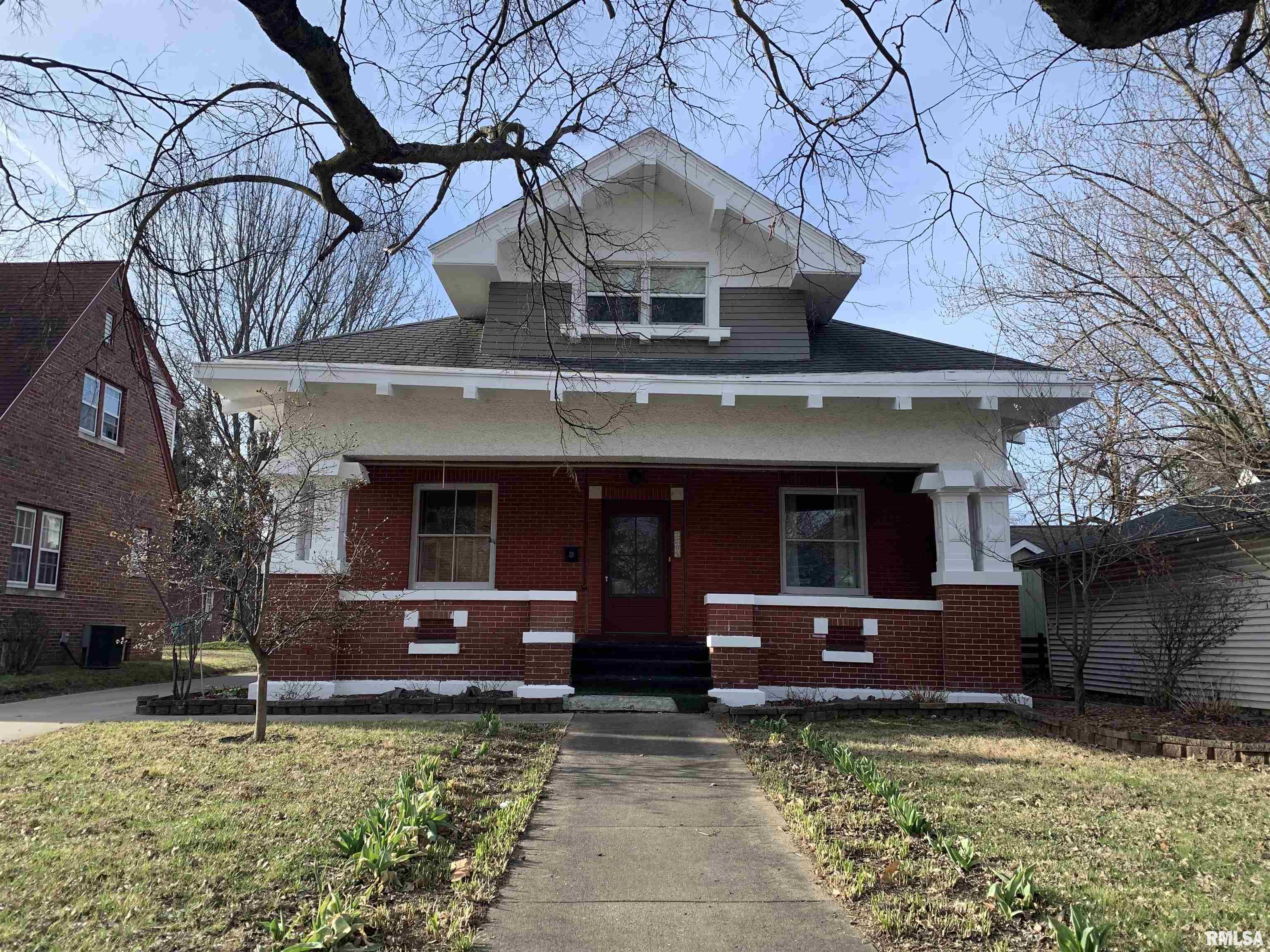 COMING SOON!   Step into timeless charm with this spacious brick bungalow located right in the heart of town! Offering 6 bedrooms & 4 full bathrooms, this home is filled with character featuring hardwood floors, original woodwork, built-ins & generously sized rooms throughout. The layout includes a cozy kitchen nook perfect for morning coffee, along with flexible space ideal for a home office, hobby area, or growing household needs. With two furnaces & two central air systems, comfort and efficiency are built right in. The second floor also features newer windows for added peace of mind. Enjoy relaxing evenings on the screened-in back porch or entertain on the outdoor decks overlooking a manageable, charming yard. Need space to tinker or create? There’s plenty of room for a workshop in the garage or basement! Lovingly maintained and cherished by the same owners for the past 20 years, this home is now ready for its next chapter.  You will love the numerous flowers, trees & birds that surround this classic home.   Other updates include water heater-'26, painting, driveway, soffits repaired & relined gutters.