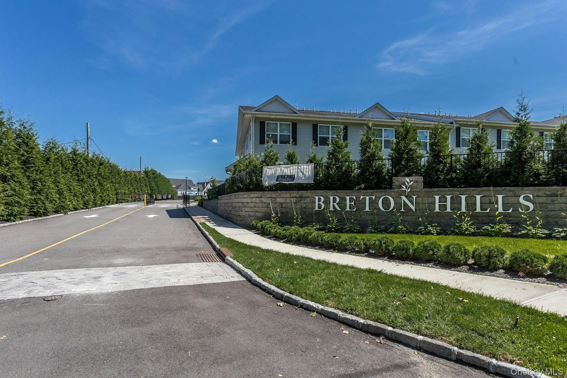 Welcome home to this beautiful & sundrenched  Luxury Condo end unit in the desirable Breton Hills Community in Glen Cove. This unit offers quality workmanship throughout, including well pointed Mill Work & Venetian Plaster. This bright and spacious home offers an open-concept vaulted ceiling living room, kitchen, and dining area, perfect for comfortable everyday living and entertaining. The Primary suite features a private en-suite bathroom, while a second bedroom and hallway bath provide additional space for guests or an office. A full size washer and dryer are conveniently located within the unit, along with a utility room and storage area for extra convenience. This Community has a beautiful vaulted ceiling Club House with Fireplace, Kitchen and Fitness Room. Stone patio and gas barbeques provide a lovely outdoor area. This active community gathers for Social activities including; Bocci, Cards & Dinners. There’s also plenty of parking and a separate garbage area for residents. This is a rare opportunity to own a modern, move-in ready condo in a secure, gated community that offers comfort, convenience, and community.Be a part of this active 55+ Gated community, centrally located to all the best the North Shore has to offer, including; Morgan Park, Prybil Beach, Glen Cove Golf Course and miles of waterfront.