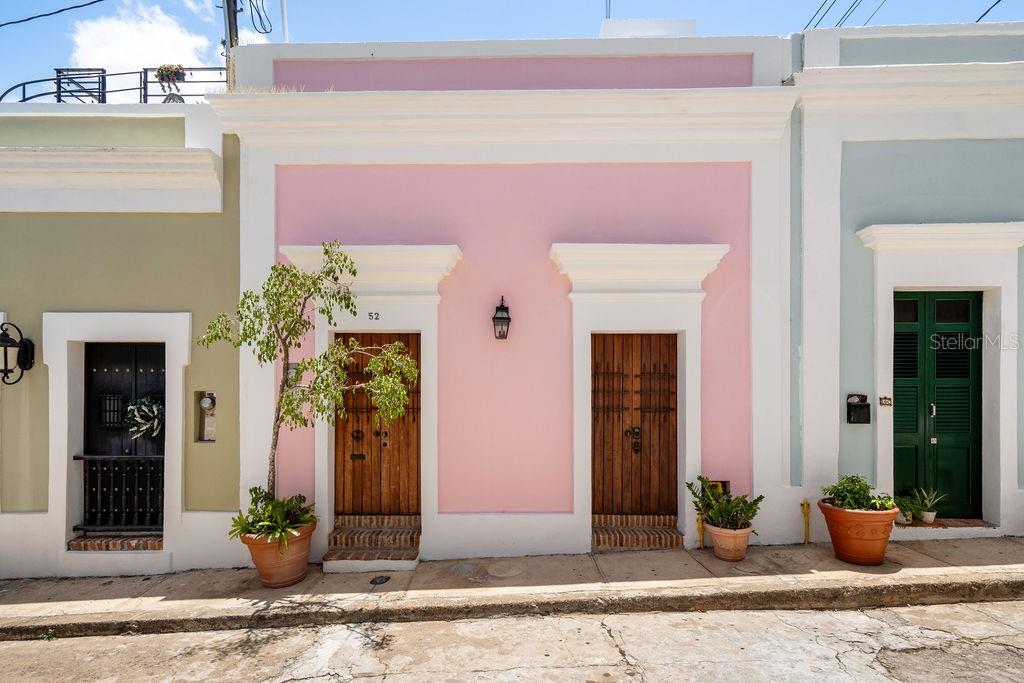 An authentic colonial jewel at Callejón del Hospital, Old San Juan, PR. Positioned within one of the most historically significant settings, this light-filled two-story residence belongs to a very limited collection of private homes surrounding Casa Blanca, placing its future owner within an environment where history is not recreated, but preserved & lived every day. Offering approximately 3,000 sf of thoughtfully restored living space, this remarkable home embodies the perfect balance between authentic colonial character, comfort, & modern systems. It is a residence where original architectural elements, peaceful surroundings, & modern functionality coexist. The home welcomes you through a gracious foyer into inviting interiors designed for intimate living. The first level features a formal living room, a family room, a versatile flex room, and a charming interior patio that introduces natural light and a sense of serenity throughout the residence. The north wall of this private interior patio is formed by a portion of the historic walls of Casa Blanca, creating an architectural connection to the origins of San Juan itself. This first level also offers two bedrooms with two full bathrooms, along with a private guest bedroom featuring its own en-suite bathroom, providing flexibility for family living, visiting guests, or multigenerational living. The entire second floor is dedicated to the private owner's retreat, creating a secluded sanctuary within this historic residence. This level features a spacious primary bedroom with ample closet space, a generous spa-inspired bathroom complete with both an antique soaking tub and a separate shower, a dedicated office area, and an adjoining flex room ideally suited as a private lounge, library, creative studio, or wellness space. The primary suite is further enhanced by direct access to a classic colonial balcony overlooking the lush gardens of Casa Blanca. Framed by centuries-old greenery, both the bedroom and bathroom enjoy tranquil views of this landmark, creating an atmosphere of serenity and offering a level of peace rarely found in the center of a historic city. Crowning this property, the rooftop terrace reveals one of the residence's most captivating treasures: sweeping views of San Juan Bay and the enchanting gardens of Casa Blanca. Beyond its architectural and historical significance, the residence offers modern infrastructure that further distinguishes it from virtually every other historic home. Among its most highly valued features is its original restored underground Spanish colonial cistern, with a capacity of approximately 5,000 gallons. Designed centuries ago, as an ingenious rainwater harvesting system, the home's original stone channels continue to capture and naturally direct rainwater into the underground cistern, where it is collected, filtered, and stored, preserving an extraordinary example of colonial engineering that remains functional today. Complementing this piece of history is a full power generator connected directly to the city's natural gas system, eliminating the need for fuel refills and providing comfort and peace of mind during power interruptions. Buying this residence is not simply acquiring real estate. It is becoming the steward of a meaningful piece of Old San Juan's heritage. A place to live fully, gather with loved ones, create memories, and preserve its story for generations to come. A colonial treasure. A rare setting. A legacy to inherit.