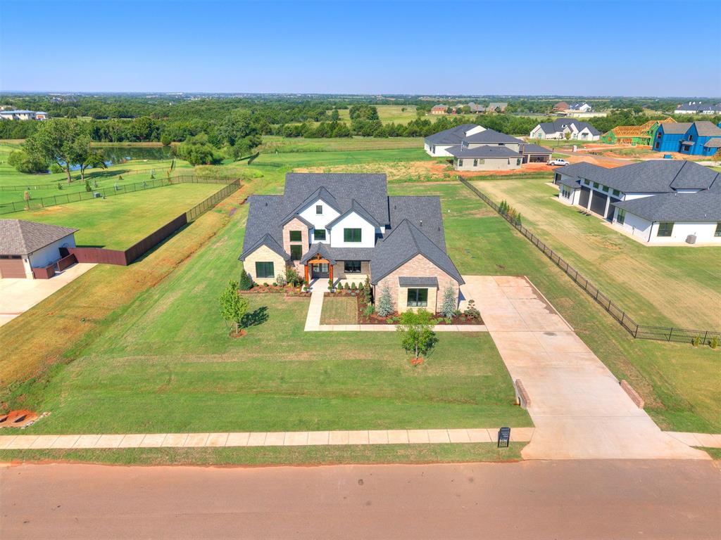 2 STORY CEILINGS | PERFECT FOR ENTERTAINING | PREMIUM 1 ACRE LOT | POND VIEW | New in Addington Farms - 1 acre lot with a unique floor plan - All in the highly sought Deer Creek School area. This home features 3 spacious bedrooms PLUS Study downstairs, and a 4th bedroom PLUS Bonus room upstairs. The main gallery features White Oak Hardwood Flooring and tons of windows for a bright and airy feel. The LIVING ROOM is SURE TO IMPRESS with 2 story ceilings (20ft), built-in cabinets and a cozy gas log fireplace with 100% efficient heat. The FRONT ENTRY also has the 20ft ceilings with an ELEVATED staircase and catwalk accented with modern iron railings. The SYMMETRY and ARCHITECTURAL INTEREST is PURE ART!. The KITCHEN features double ovens, gas cooktop, pot filler faucet, walk-in butlers pantry, and upgraded cabinets to the ceiling. The STUDY has elegant built-ins, 6 inch crown and french doors to the entry. The Primary bedroom has a vaulted ceiling with wood beams, added lighting and views to the backyard. The spa-like Primary bath is spacious with a double vanity, freestanding tub, walk-around double shower, and huge walk-in closet connecting to laundry room. The back patio has an outdoor fireplace and electric to mount a TV - also has views to a pond and faces across the backs of lots so there are no homes directly behind you! Comfy Cozy Cool and Chilly - the new HYBRID INSULATION includes SPRAY FOAM exterior walls and blown-in attic insulation for a superbly QUIET and ENERGY EFFICIENT home! So much to love - COME SEE TODAY!