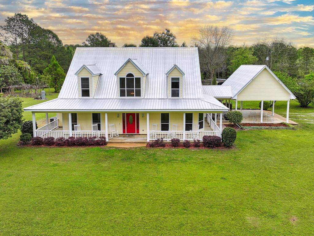 This stunning property is a perfect blend of luxury and functionality, offering 48 acres of beautiful land with a gorgeous home. The spacious residence features 3 bedrooms, 2 full bathrooms, and 1 half bathroom, along with a huge bonus room that can serve as a game room, office, or additional living space. The heart of the home is the kitchen, open to the living room, creating a welcoming space for family gatherings. The kitchen boasts custom wood cabinets, sleek quartz countertops, a stunning custom backsplash, and a gas cooktop, making it both stylish and functional. Throughout the home, you'll find engineered hardwood flooring, tile flooring, and granite countertops in the bathrooms. The master bedroom is a true retreat, featuring its own cozy fireplace and a private porch where you can relax and enjoy the breathtaking views of the surrounding land. The 48 acres of property offer a variety of possibilities. The thinned planted pines provide a plantation-style atmosphere, while the hardwoods offer excellent hunting opportunities for deer and turkey. Enjoy the bounty of fruit trees and muscadine grapevines, and if you're an animal lover, some of the land is already fenced and cross-fenced for livestock such as cows or horses. A chicken coop is already in place, adding to the versatility of the property. Additional amenities include 4 workshops/storage buildings (2 of which are wired) and a wired playhouse, providing ample space for hobbies, storage, or workshops. For ultimate relaxation, enjoy the saltwater swimming pool and hot tub—perfect for unwinding after a long day. This property offers endless options and is easy to maintain, making it hard to pick a favorite feature—whether it's the beautiful land, the luxurious pool, or the stunning home. Don't miss out on this incredible opportunity!