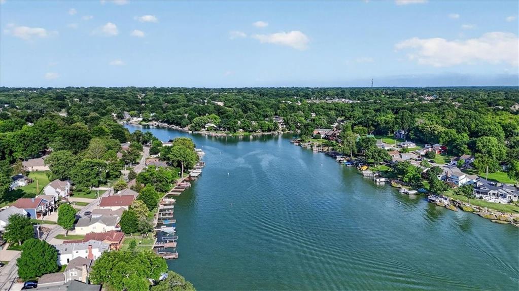 Step into a piece of history on the shores of Lake Tapawingo—a one-of-a-kind lakefront home that captures the essence of timeless charm and everyday escape. As one of the original homes built in this community nearly 100 years ago, this property blends rich character with thoughtful modern updates, creating a rare opportunity to own a legacy. Much of the original log structure remains, giving the home an authentic lake lodge feel that’s warm, inviting, and impossible to replicate. Inside, you’ll find three bedrooms, two baths, a dedicated office, and a stunning sunroom with heated floors—perfect for year-round enjoyment. The newer kitchen is designed with hosting in mind, featuring an oversized refrigerator and seamless access to the new front deck, ideal for morning coffee or evening gatherings.Outdoor living is just as exceptional. Enjoy a lakeside patio with pergola, a beautifully curated butterfly garden that brings nature to life, and a newer double-decker dock built for making the most of every season on the water. The main-level primary suite provides privacy and convenience, while two additional bedrooms upstairs create a separate retreat for family or guests. A two-car garage adds everyday functionality to this unique property. Bonus: the new owner gets to enjoy a new front deck and a newly painted exterior! Life at Lake Tapawingo is more than just a home—it’s a lifestyle. With a strong sense of community, you can be as involved as you’d like through the local sportsman’s club and women’s club, both offering events year-round. And of course, the lake itself is the centerpiece—offering incredible fishing (bass, catfish, bluegill, and crappie), along with water skiing, wakeboarding, kayaking, paddleboarding, and endless days spent floating with friends.This is more than a home—it’s your everyday getaway. Come experience why lake life truly is the best life.Video link: https://drive.google.com/file/d/1QCy0jQlga8Pz7ImjfdNtxlIcduOKv1xb/view?usp=sharing