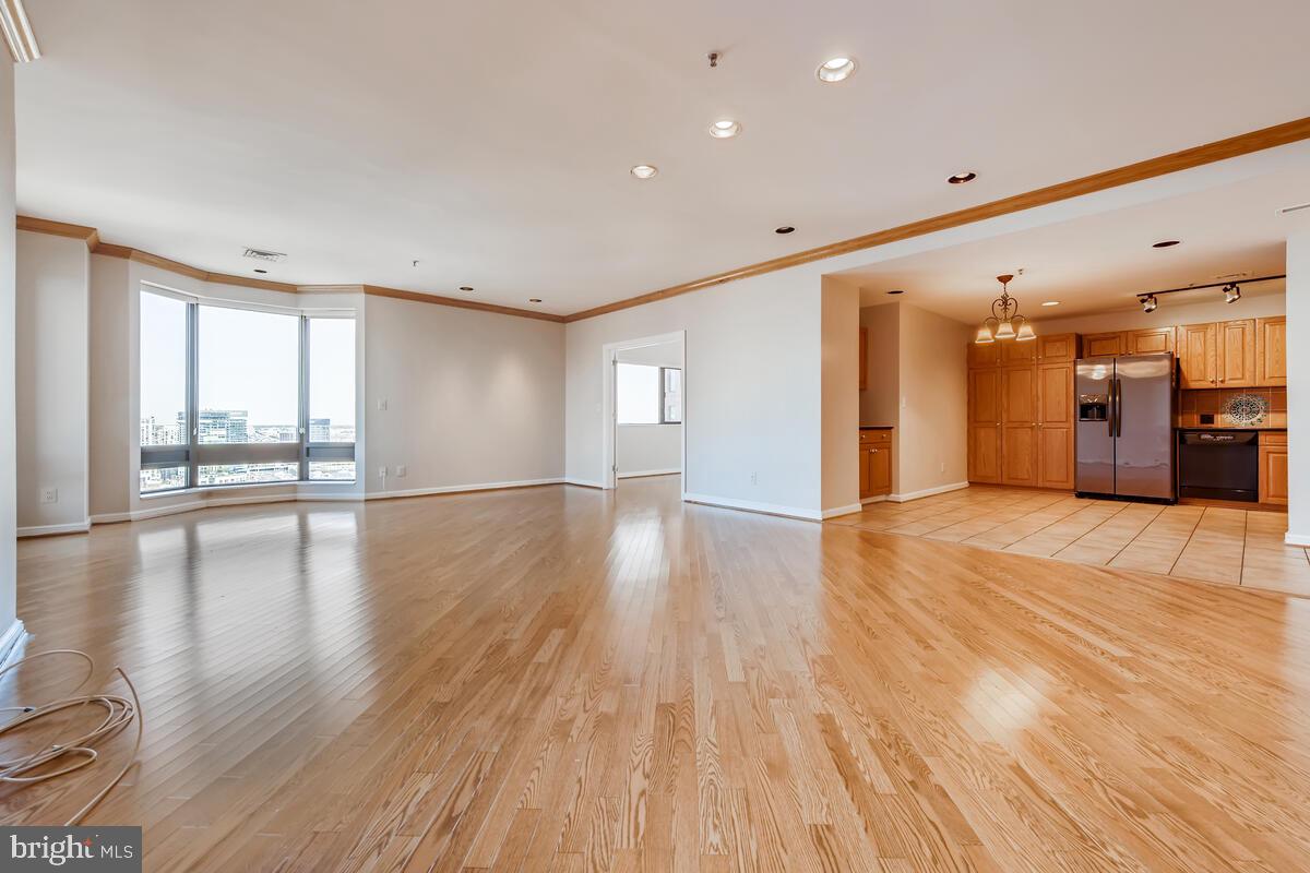 Twenty-sixth floor unit offers direct harbor views from every room!  Highest floor for this floorplan.  Stunning water and city views!  Granite open kitchen. Hardwood floors and giant walk-in closet area.   Full-size side-by-side laundry.  Parking in attached garage included.  Full-service secure elevator building has 24-hour desk, doorman, parking attendant.  Attached to Royal Sonesta Hotel.  Generous square footage and open layout.   Some of the best direct inner harbor views you can find.