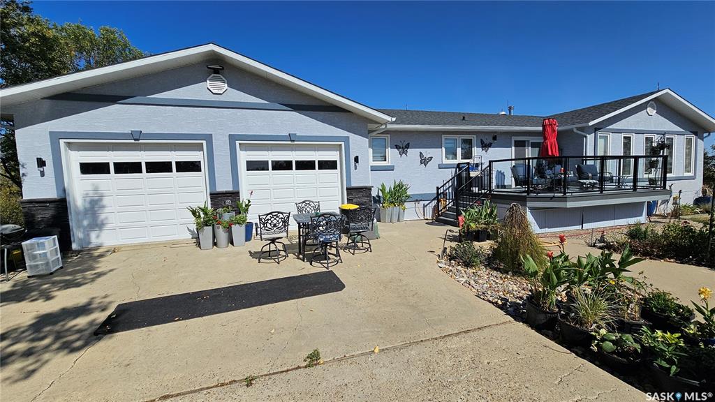 Now this is country living at its finest! Just 2.5 km south of Cabri on Highway 37, you will find this sprawling 2,176-sq. ft executive bungalow nestled serenely on 4.44 acres of land. The enormous kitchen is fit for any farm-to-plate chef. It boasts 52 drawers and cupboards, a large central island with a built-in cutting board, a 2-burner electric stove, and a prep sink. The upgraded stainless steel appliances are accentuated by updated lighting, so you are cooking comfortably day or night. Past the entertainment room, you will find a cozy nook that could have a myriad of uses and also ushers you through French doors into your huge primary bedroom with its updated 3-piece ensuite. With a formal dining area, 2 other bedrooms, 5-piece and 2-piece bathrooms, and the convenience of main floor laundry, you won’t want for anything with this layout. Take the spiral staircase to the basement, or use the secondary access for easier furniture moving. Either way, you will find more room than you will know what to do with. The rec room features a wood-burning stove for those times the power may go out, and a recessed library area. There are 2 more bedrooms, a 6-piece bathroom, and tons of storage space. Windows and the roof have been replaced within the last 8 years, there is a multi-stage water purification system, and upgraded electrical. Not only do you have a 26x24 double attached heated garage, but you also have a 25x40 heated shop, not to mention a chicken coop, greenhouse, 4 dog runs, an outdoor cookhouse, and a relaxing hot tub. And to keep everything green and growing, there is an underground sprinkler system. Survey it all sitting on your 12x16 deck with tempered glass and black aluminum railings as you watch the birds fly, listen to the crickets chirp, and watch the combines in the field. You aren’t the only one dreaming of this, so be sure to call about this oasis before it is gone.