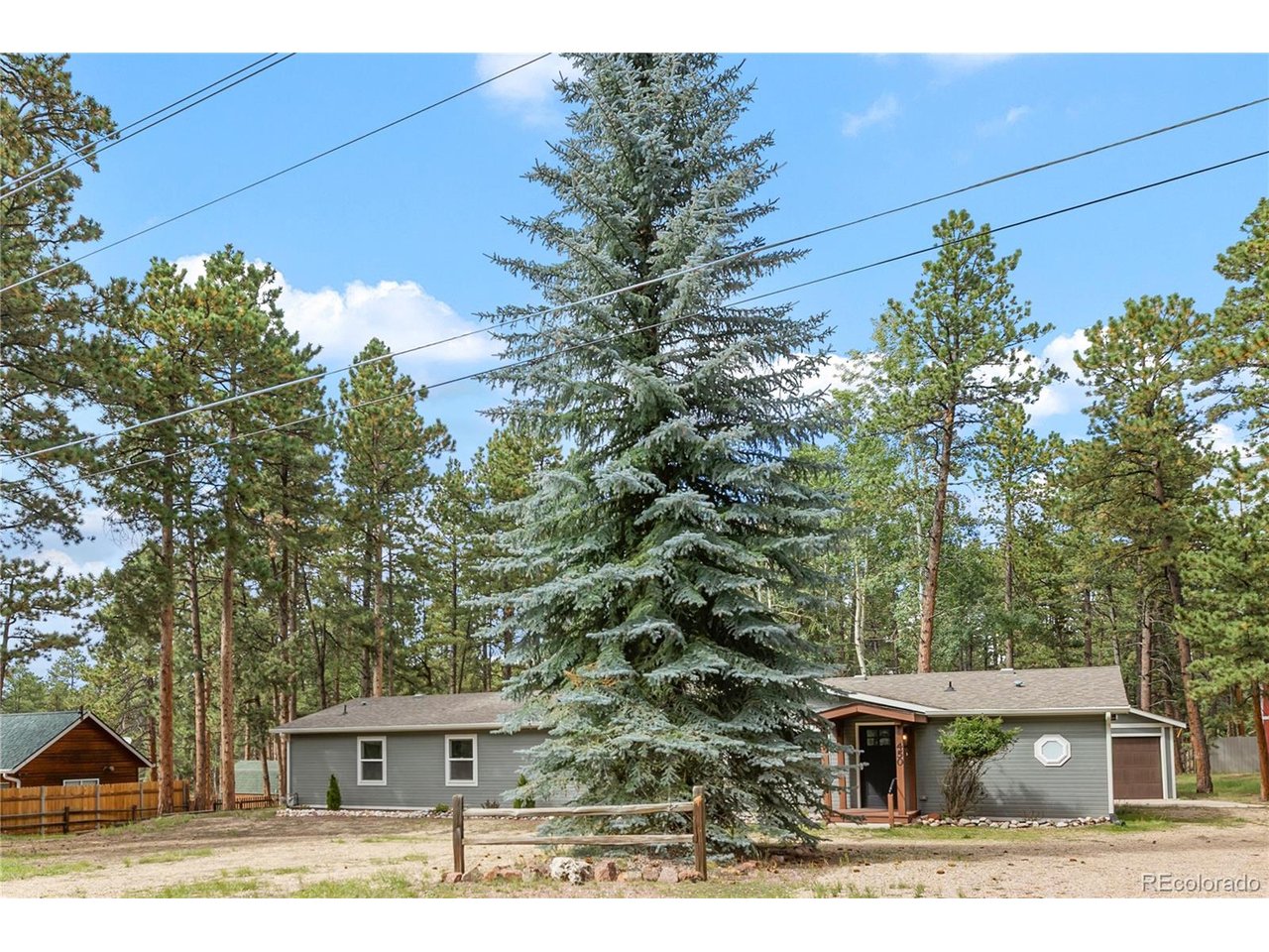 MOTIVATED SELLERS!!! SELLERS will consider a $20,000.00 BUY DOWN/CONCESSION. Fully updated inside and out, this beautiful rancher sits on 0.68 acres in Woodland Park's Central Park area, with mature Ponderosa and aspen trees in the backyard. The front yard features a beautiful spruce tree, perfect for holiday decorating. Inside, you'll find the beautiful Colorado Marble accents in the bathrooms and kitchen, new recessed LED lighting, and updates throughout. Tons of natural light feeding in. The primary bedroom is privately located on one side of the home and features a five-piece adjoining bath, double closets, and additional office space. The spacious living room offers plenty of room to relax and entertain. The kitchen has been completely updated with new cabinets, marble countertops, and new appliances. Lots of cabinets offer tons of storage! A Jack-and-Jill bedroom arrangement includes an adjoining 3/4 bath. Separate laundry room with washer and dryer included. No HOA dues. The detached two-car garage features a new garage door. Furniture is negotiable. This home offers so much and is truly move-in ready. Easy access to local restaurants, shopping, grocery stores, schools, parks, and community amenities. Enjoy the best of mountain living while still being close to everything you need. Come see all the updates and make this beautiful Woodland Park home your own!
