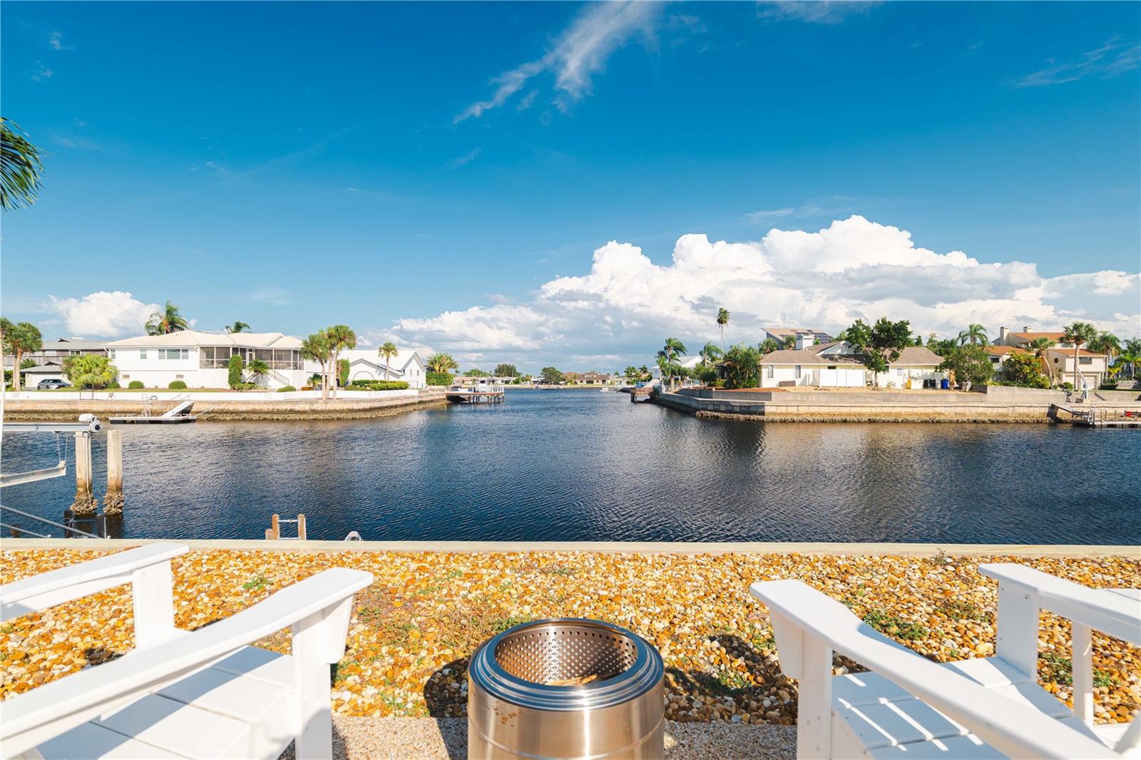 Paradise awaits at this exceptional 3-bedroom, 2.5-bath waterfront estate with a detached 2-bedroom in-law suite on a double lot in New Port Richey. Resting proudly on 0.43 acres, this 4,018 SqFt home blends luxury, resilience, and comfort—having weathered two hurricanes with no damage or flooding. Fully restored in 2017, the main home features a chef’s kitchen with vaulted beamed ceilings, granite counters, stainless steel appliances, double ovens, and a spacious pantry. The expansive great room opens to tranquil waterfront views and an entertainer’s lanai. French doors lead to the primary suite, which includes a bonus room (currently used as a gym), a spa-like bath with soaking tub, dual sinks, and custom California Closets.
Outdoors, enjoy the open-air saltwater pool, tiki hut with power and lighting, and a private dock with concrete pilings and a 16,000 lb boat lift. For the car enthusiast or RV owner, the 45’x38’ detached garage offers storage for 4–6 cars, RV access, and a second-floor in-law suite with 2 bedrooms, full kitchen, bathroom, and private balcony with water views. Additional features include a 2-car attached garage, solar water heater, 20 owned solar panels, plantation shutters, and lush landscaping. This is luxury waterfront living—designed for boaters, RVers, and anyone who craves space, style, and security.