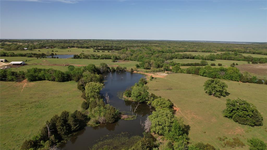 Ripe for investment opportunities, this 197+ acre ranch property is a dream for those seeking their own piece of Texas paradise. Adjacent to Corps of Engineers land and near Lake Texoma, the ranch offers rolling terrain with varied topography, spectacular panoramic views, plenty of mature trees scattered throughout, pastures for grazing cattle, wooded areas, and multiple tanks stocked with catfish and bass. The location is ideal. Access to Lake Texoma can be found minutes away at Juniper Point ramp and Walnut Creek Resort. The property is also near the coming soon Hard Rock Hotel and Residences as well as the newly planned Margaritaville resort in Denison. The property has a quaint 4-bedroom, 2-bathroom country home at the front that offers a spacious living area, an open eat-in kitchen with a separate dining area, four large bedrooms including one with an en-suite, and a covered front and back patio. Outside, you'll find two outbuildings totaling 3,200 sqft and 2,800 sqft of carport space. Only an hour from the DFW metroplex and minutes from shopping and entertainment, this property truly is a gem!