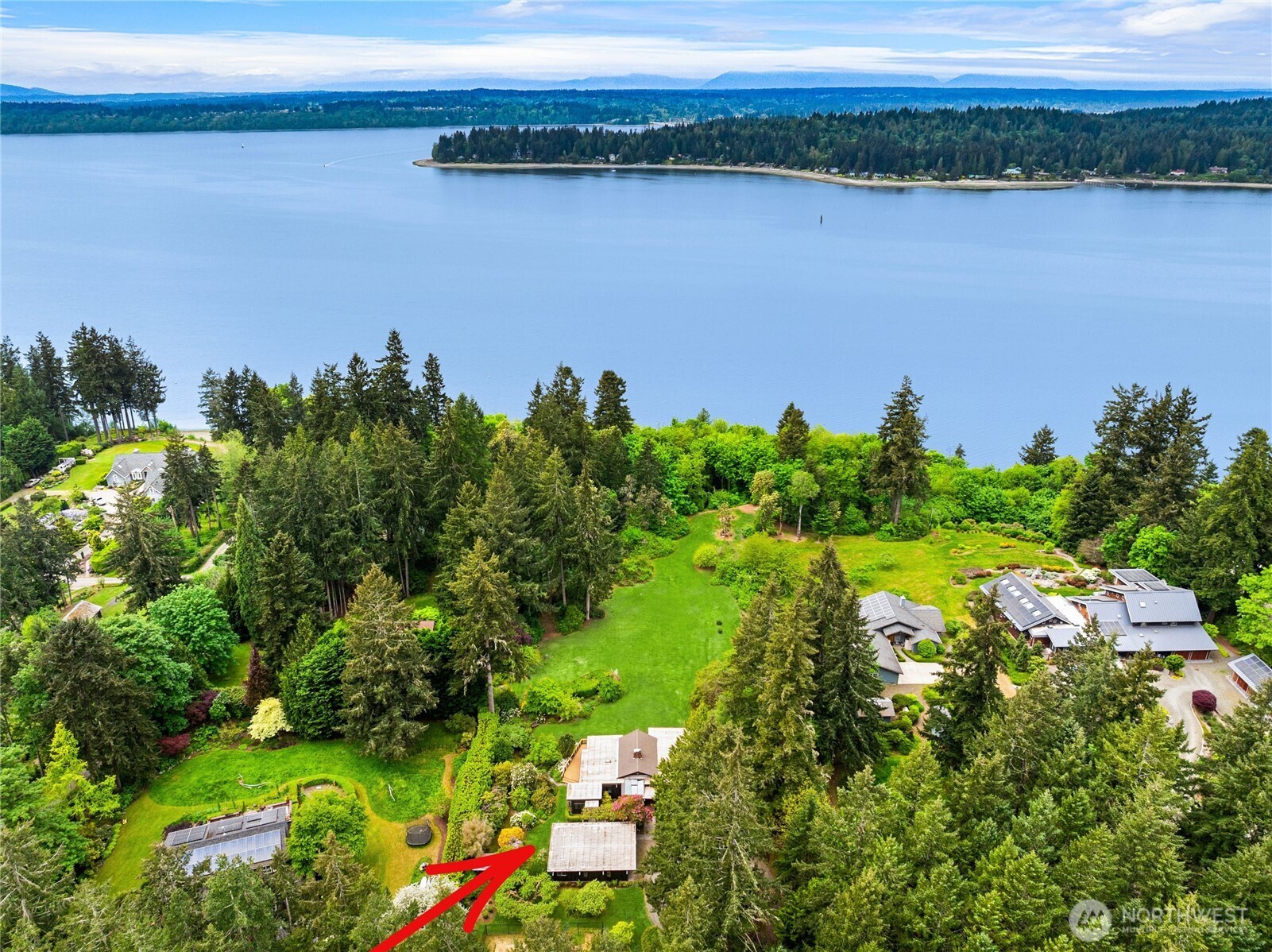 Exceptional island property with over 3 acres of sunny land with western exposure, 65' of waterfront, new stairs to beach, 3 lots and an existing home. Built in 1964, the mid-century gem of a home is architecturally designed and was his family’s home. Crafted with intention and care, the 4-bedroom house is a time capsule that features stunning fireplace and chimney with bricks reclaimed from a Pioneer Square building demolition and clear tongue and groove cedar siding. Beautiful gardens surround the home with many mature species rhododendrons and heritage fruit trees. Two additional detached structures include a 2-car garage and RV/boat garage. Offered as part of the package are two 1-acre lots. One of the two lots shares in a two-party well that serves the house. A second well has been approved by KCHD. BLA (to be recorded) includes utility and access easements, plus beach access and use easement. New, fully permitted stairs to beach. The property has a 9-year management/tree removal plan for the slope that will allow for increasing Sound and Olympic Mountain views.
