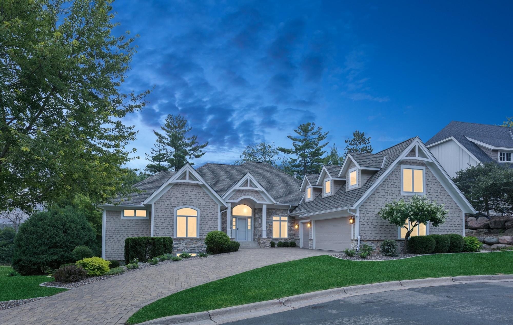 Discover lakeview luxury in this custom-designed 4-bedroom, 5-bathroom rambler overlooking scenic Bush Lake in Bloomington. Thoughtfully crafted for comfort and elegance, this spacious home offers Venezuelan walnut floors, solid cherry doors, and 14’ ceilings in the main living area, with panoramic water views throughout. The gourmet kitchen is a chef’s dream, featuring high-end Sub-Zero, Wolf and Miele appliances, a large center island and an informal dining area with an octagon ceiling—perfect for both everyday living and entertaining.  The main-floor primary suite is a serene retreat with tranquil lake views, boasting heated tile floors, dual vanities, a walk-in tile shower, and soaking tub in the spacious bathroom. Additional features include a home office with built-ins, mudroom with lockers, main-floor laundry, and a flex room - ideal for a gym, playroom, or studio - over the 3-car epoxy-finished garage. The walkout lower level is built for relaxation and entertaining with in-floor heating (Wirsbo system), a spacious family room, walk-up wet bar with refrigerator and dishwasher, a Jack-and-Jill bathroom, and a private guest suite.  Step outside and enjoy everything Bush Lake and the Hyland Park Preserve have to offer—fishing, kayaking, paddleboarding, hiking and biking, or simply taking in the peaceful surroundings.  A new roof and landscaping were installed in 2024, providing peace of mind and long-term value.
Don’t miss this rare opportunity to own a close-in, custom lakeview home with luxurious finishes and direct access to nature, all just minutes from parks and trails.