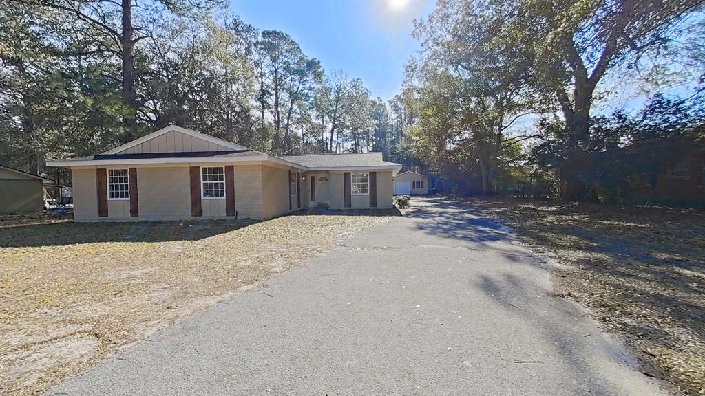 Like new. Right in the middle of everything. And ready for its next chapter.  Perfectly placed inside the city limits, this home puts you seconds from shopping, groceries, and restaurants — and just minutes from downtown Thomasville. Whether you're running errands, meeting friends, or heading home after a long day, everything is right where you need it. This classic all-brick home has been thoughtfully remodeled from top to bottom, blending its original charm with fresh, modern updates. Nearly everything is new — from the roof and wiring to the floors, fixtures, cabinets, and appliances — while still keeping the solid bones that make older homes so special. You'll immediately notice the natural light pouring through the oversized windows and the spacious, easy flow of the home. The oversized living room is perfect for hosting, relaxing, or doing absolutely nothing at all. The kitchen is a true refresh with:  New cabinets  Granite countertops  Stainless refrigerator, stove, microwave & dishwasher  Pantry closet  Separate dining area The extra-large flex room on the opposite end of the home is a game-changer — office, craft room, gym, second living space you name it. It also features a spacious laundry closet with custom wood shelving. The primary bedroom offers double closets and a private bath with a natural wood barn-door style vanity and tub/shower combo. The guest bedrooms are just as roomy, each with custom shelving, and the guest bath matches the same warm, modern style. Outside, you'll find:  A detached 1-car garage that doubles as a workshop  A spacious backyard  A concrete patio ready for your grill, string lights, and weekend plans  Fresh exterior paint and newly stained wood shutters Other updates include: New roof, re-ran electrical, new flooring, lighting, fixtures, countertops, cabinets, appliances, added hall coat closet, and fresh interior & exterior paint. Whether you're a first-time buyer, moving up, downsizing, or adding to your rental portfolio — this home fits more lifestyles than you might expect.  Homes like this don't sit around waiting. They get claimed.  If this one made you smile even a little imagine how it'll feel in person. Call, text, DM, or send a smoke signal to your Agent to schedule your showing before someone else does.