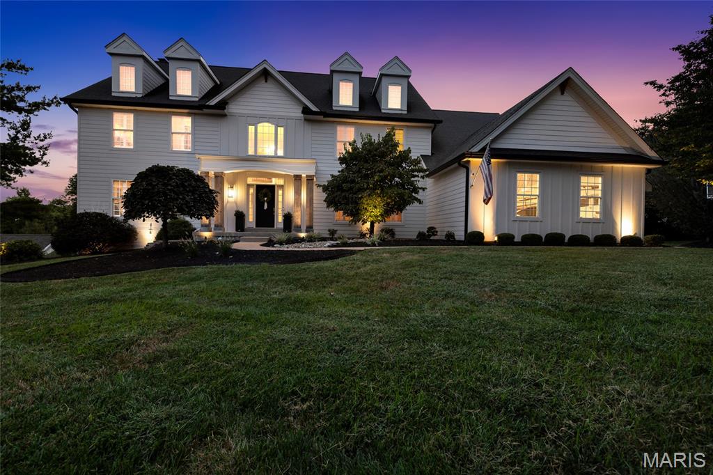 Welcome to 1109 Windridge Estates Lane, an exceptional residence set on a private 0.73 acre lot in the heart of Chesterfield. Offering approximately 6,000 square feet of meticulously finished space, this 5 bedroom, 4.5 bath two story home pairs refined interiors with resort inspired outdoor living. A beautifully renovated exterior accented by warm wood details and charming dormer windows creates striking curb appeal. Inside, a light filled grand foyer showcases a redesigned dual staircase and opens to an elegant formal dining room and dedicated office with designer built-ins. Crown molding, custom shutters and luxury vinyl plank flooring lend a polished aesthetic throughout the main level. Designed for entertaining, the inviting living room features a gas fireplace framed by shiplap, built-ins and a dramatic window wall. The spacious kitchen is appointed with a tiered center island and breakfast bar, stainless steel appliances, double wall ovens, walk-in pantry, butler's pantry and adjoining breakfast room with deck access. An impressive vaulted hearth room offers a second gas fireplace, built-in speakers and a wall of windows overlooking the backyard. Main floor laundry and an updated powder room add everyday convenience. Upstairs, the primary suite provides a serene retreat with tray ceiling, generous walk-in closet and spa inspired bath featuring dual vanities, heated floors, soaking tub and tiled shower. Three additional bedrooms include one with a dedicated ensuite bath and two connected by a shared bath, each offering a walk-in closet. The finished walkout lower level extends the home's versatility with a family room, recreation area, fifth bedroom, full bath and substantial storage, with direct access to the lower patio and exceptional outdoor amenities. Outside, a resort inspired retreat awaits. The expanded deck overlooks a heated inground saltwater pool, hot tub, covered pergola seating and fully fenced backyard, creating an enviable setting for entertaining, recreation and relaxation. An oversized side entry, 3 car garage, professional landscaping and irrigation system complete this distinctive Chesterfield residence with over $300k in owner investment. Ideally located within the award-winning Rockwood School District, just minutes from Chesterfield Valley shopping, dining and recreation with convenient access to Highway 40/64.