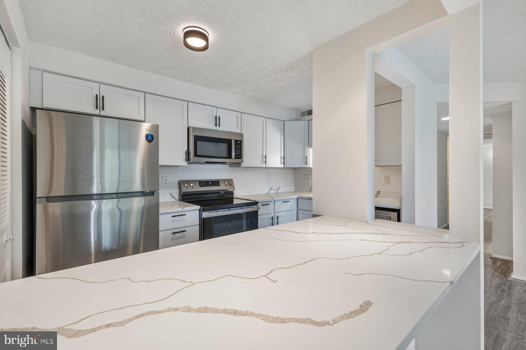WOW! Don't miss this fully renovated 2-bedroom, 2-bath home in one of Alexandria's most convenient locations. This unit has been updated from TOP to BOTTOM and is move-in ready, offering fresh, modern finishes throughout.The living and dining areas are bright and open, with brand new LVP flooring and fresh neutral paint flowing throughout the unit. A sliding glass door fills the living room with natural light, and the layout connects the living and dining spaces naturally..The kitchen has been completely renovated in 2026 featuring crisp white shaker cabinets with matte black hardware are paired with gorgeous quartz countertops. Stainless steel appliances include a refrigerator, electric range, over-the-range microwave, and dishwasher. A pantry closet off the kitchen adds excellent storage space.The primary suite includes a brand new private en-suite bath for comfort and privacy. The second bedroom works equally well as a guest room, home office, or flex space. Both bedrooms are generously sized. Bathrooms have been updated with new vanities, fresh tile, and modern lighting fixtures in 2026.In-unit laundry with a full-size washer and dryer is a standout convenience, tucked neatly into a dedicated laundry closet.Updated lighting and new windows throughout. Recent updates include brand new HVAC and water heater.Mount Vernon Lakes Condominium offers residents basketball courts, tennis courts, a jog/walk path, tot lots/playground, and common grounds. One reserved parking space conveys, with plenty of visitor parking available on site.Zoned for Riverside Elementary School, Whitman Middle School, and Mount Vernon High School.Monthly condo fees cover Common Area Maintenance, Insurance, Reserve Funds, Sewer, Snow Removal, Trash, and Water. A quarterly HOA fee also applies. Located in the Mount Vernon area of Alexandria, this community puts you close to everything that makes Northern Virginia living so convenient. Route 1 and I-495 are easily accessible, connecting you to Fort Belvoir, the Huntington Metro station, Old Town Alexandria, and the broader DC metro area with ease. A wide range of shopping and dining options line the Richmond Highway corridor, and National Harbor is just a short drive across the Potomac for dining, entertainment, and waterfront recreation. Outdoor enthusiasts will appreciate the proximity to the Mount Vernon Trail, Potomac River parks, and George Washington's Mount Vernon Estate. Whether you're commuting for work or exploring on weekends, this location has you covered. Some photos are virtually stagedMake your appointment today!