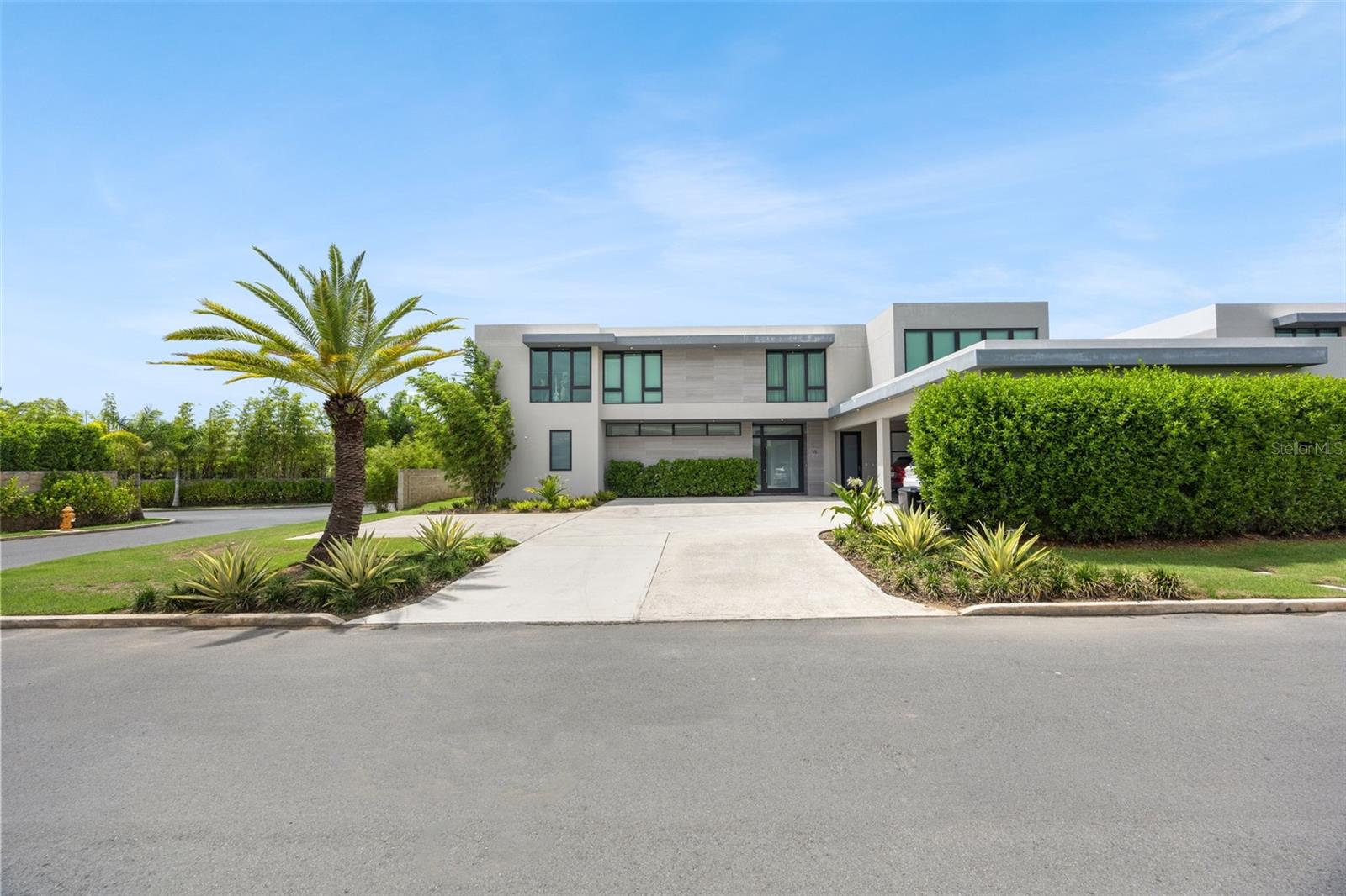 Exceptional two-story corner residence in Riviera Reserve, featuring the Extension Estate Plus configuration—an expanded version of the original estate that distinguishes this home with additional living space and a larger footprint; with approximately 6,986 square feet on a 1,156 square meter lot. The open-concept layout is anchored by an impressive living room with 20-foot ceilings, complemented by elegant dining and bar areas and a beautiful Italian kitchen with premium appliances.With interiors curated by Cecilia Refojos Atelier, including thoughtfully selected décor and custom-designed furniture, the residence features a spacious primary suite with a walk-in closet and ensuite bathroom, three additional ensuite bedrooms, a home office, private family room with a full bathroom, and ensuite maid’s quarters. Thoughtfully appointed for everyday living, the home also includes laundry rooms on each floor. An expansive backyard provides generous outdoor space with possibilities for recreation, entertaining, or future customization. Additional features include impact resistant windows, central A/C, solar water heater, emergency water cistern, and a three-car garage with plenty of storage, providing convenience and peace of mind.Riviera offers an exceptional resort-style amenities designed for recreation, wellness, and everyday enjoyment. Residents have access to the Riviera Tennis Center, featuring tennis, beach tennis, pickleball, and padel courts, as well as the Grand Club, complete with a swimming pool, outdoor terrace, lounge, event room, and fitness center. The community’s Urban Park further enhances the lifestyle with gazebos, a playground, basketball courts, jogging trails, a dog park, and expansive green areas. Coming soon, Riviera Marketplace will bring additional convenience to the community with a coffee shop, restaurants, medical offices, and other services.Extension Estate Plus LayoutTwo-Story, Corner Unit6 Bedrooms | 6.5 BathroomsApprox. 6,986 SF of Construction