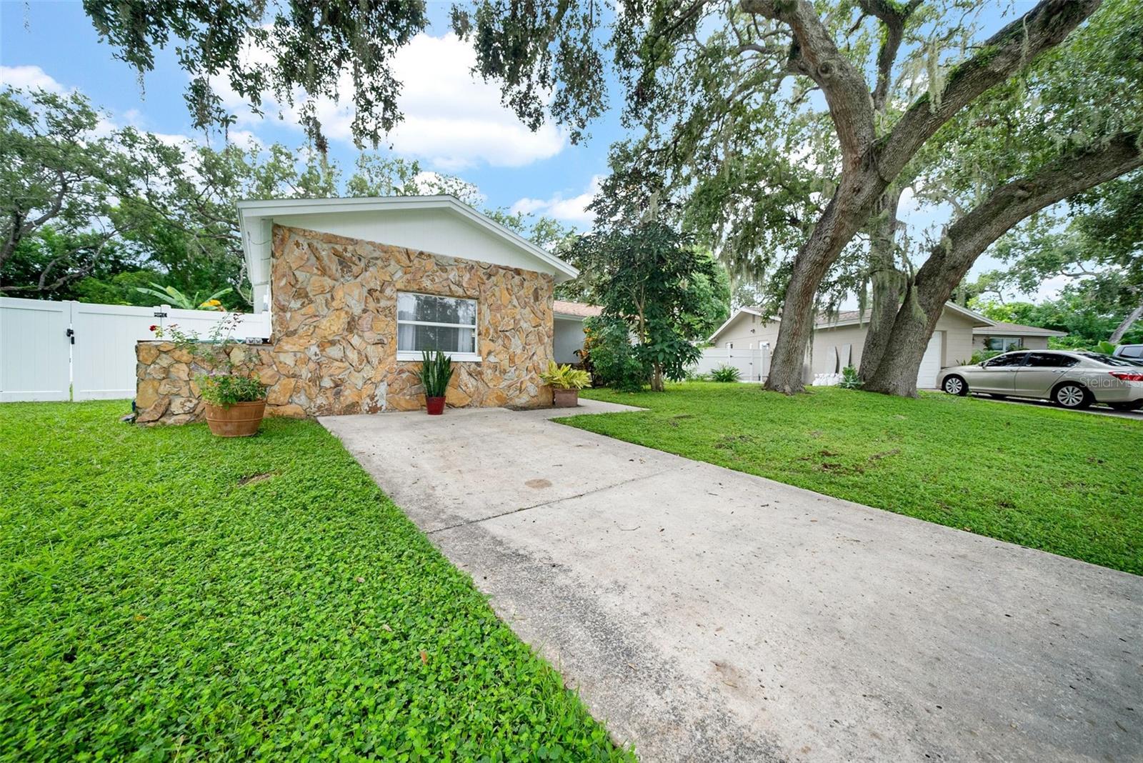 Live the Florida Dream!  Welcome to this spacious 4-bedroom, 1-bath home in the desirable Highpoint Estates neighborhood in Unincorporated Clearwater. Featuring a split, open floor plan, this light and bright home offers plenty of natural light throughout.  Enjoy tiled floors in the main living areas and cozy carpet in the bedrooms. The newly-remodeled kitchen comes with newer appliances and French doors open to your private covered patio overlooking a very large fenced back yard perfect for entertaining or fur babies.  Additional highlights include: Inside laundry room,  Vinyl-fenced yard on an oversized lot (plenty of room for a pool!), ROOF (2022), HVAC (2015), W/H (2018). With no HOA and a quiet, charming sidewalk community, this home offers both convenience and piece of mind with all big ticket items done. Located just minutes from, shopping, dining, schools, and airports, it’s an ideal place to call home.  Don’t miss this opportunity — schedule your private showing today!