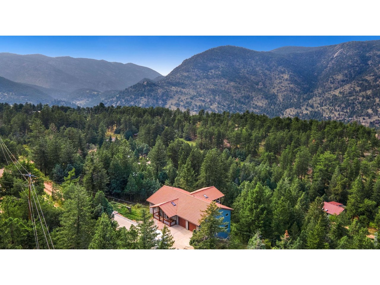 Kittle Real Estate presents a home nestled among the breathtaking Rocky Mountains, this captivating retreat stands as a hidden treasure longing to be uncovered. Well-maintained by the original owners w/ an extensive array of features and amenities. Step inside the flexible, open-concept living space w/ impeccable interior designs and quality finishes. Combining vaulted ceilings, skylights, and custom light fixtures creates an expansive and luminous atmosphere. The fully updated kitchen is a showstopper, featuring high-end stainless steel appliances, a 6-burner gas stove, luxury granite countertops, a double basin farmhouse sink and prep sink w/ touchless faucets, a huge center island that is loaded w/ storage solutions, and custom soft close cabinetry. Mix your favorite cocktails at the handcrafted bar and sip them on one of the 3 Trex decks while you gaze out at the awe-inspiring views of Longs Peak. In the owner's wing you will find a spacious bedroom and a beautiful bathroom w/ jetted soaking tub and a walk-in shower w/ a waterfall showerhead. The views from the office immerse you in the tranquil wilderness, while the high-speed Fiber Optic internet ensures seamless connectivity. The lower level offers even more space to relax and entertain. Watch a movie while you cozy up next to the fireplace, or head into the rec room for a game of pool. Two basement bedrooms and a guest bath. Indulge in the beauty that envelops this .94-acre property, providing the peaceful Colorado lifestyle you desire. One of the standout features of this home is its private well, offering high-quality drinking water, unlike many nearby homes tied to the Pinewood Springs system. Endless outdoor activities from hunting and fishing to hiking and biking. Minutes away from Rocky Mtn National Park and Estes Park shopping, plus easy access to Lyons, Boulder, Denver, and a variety of ski resorts! Short-term rental potential.