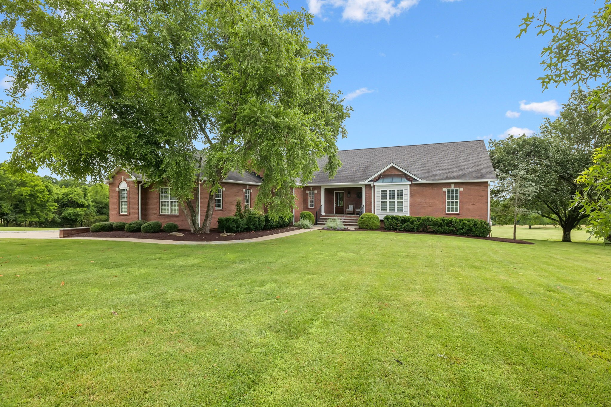 Dream estate on over 11 acres in one of the most secluded areas of Davidson County. Pristine golf course-like grounds on the edge of the 636 acre Peeler Park with its miles of greenways and equestrian trails. If you have a high profile client or the client who needs discretion and security, this is THE place! Current owners reimagined the home with an amazing architect and created the floor plan and design that truly makes the home as close to perfect as possible. Four bedrooms are now on the main entry level with an enormous living room and dream designer kitchen. Tons of light pours through the walls of windows overlooking acres of lush greenery. Downstairs, a huge storage room transitions you to a full, two bedroom apartment in-law suite. Fully redone, it boasts a new kitchen and bath, also. A third garage is on the basement level for farm toys or another vehicle. Located on a country road, the only reason anyone has to drive out Hudson is visiting a friend or going home, no thoroughfare traffic. The drive out is lined with horse properties and homes with generous acreage. While private, the site is only seven minutes to the new Rivergate redevelopment, Pinky Ring Pizza, the new music venue Harkin Hall, Amqui Station Farmer's Market, Shotgun Willie's, Yazoo Brewery, and Daddy's Dogs. Downtown Nashville and the airport are less than 20 minutes away.