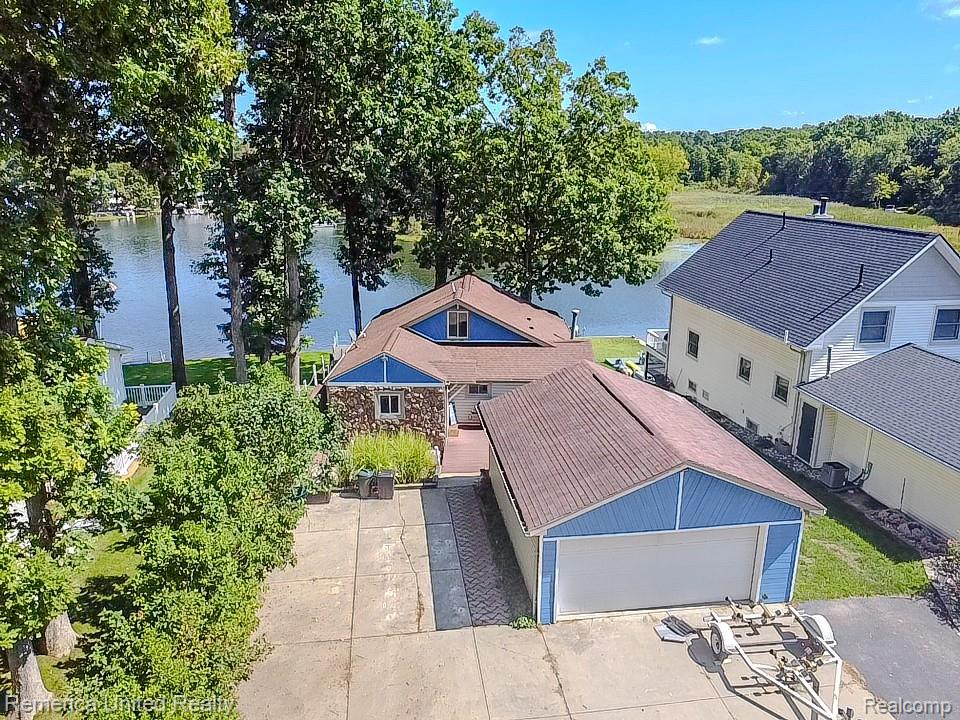 Enjoy lake life now with this move-in-ready Lobdell Lakefront home! With 54 feet of frontage on a serene, more secluded section of the lake, this 3-bedroom, 3.5-bath home offers the perfect blend of relaxation and functionality. The main floor features a spacious primary suite, a 2nd bedroom and a laundry room (not closet). Enjoy stainless appliances, great countertop space and a breakfast nook in the updated kitchen. Natural light pours through the home, especially in the living room, where wall-to-wall windows and skylights showcase peaceful views. 

A cozy sitting room just off the breakfast nook offers flexible use - perfect as a formal dining space, reading nook, or home office. Upstairs, a charming loft-style bedroom with a private half bath. The completely rebuilt walkout lower level (new structure entirely) offers a bright family room with even more lake views, ideal for entertaining.

Outside, enjoy expansive decking & dock. The oversized circle driveway provides rare, abundant parking for lakefront living and leads to a large detached 2-car garage plus an XL shed for storing all your lake toys. Surrounded by great neighbors and move-in ready with immediate occupancy. **more photos will be available on Friday, Sept 5th**