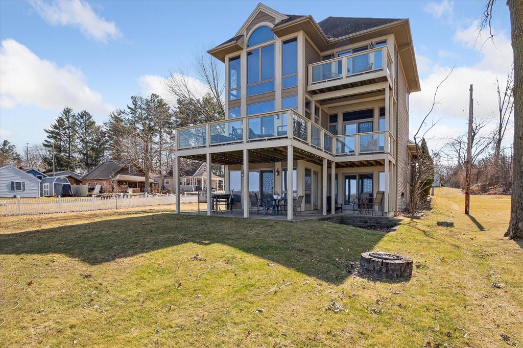 Don't miss the opportunity to live in this Clark Lake home with stunning views from every living space and almost half an acre of outdoor space! This well thought out custom build has 3 bedrooms and 3 full bathrooms. There is a bedroom and a bath on each level to give privacy to everyone in the home. A conveniently located 1/2 bath in the loft area where you can have another living area/office or playroom. The wall of windows covering the entire front give wonderful views year-round. Dock stays and you can be on the lake all summer! Whole house has speakers to play music and you can turn on or off in each room as needed. New in 2023 a Generac whole house generator. Seller will also sell furnished at $952,000.00