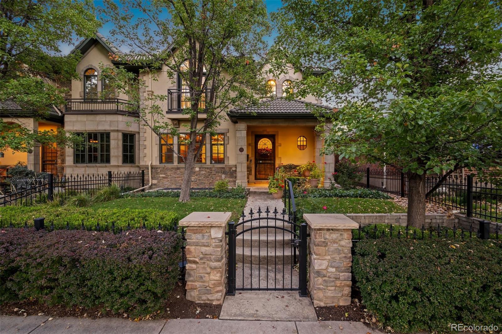 Ideally positioned in the heart of Cherry Creek North, 542 Adams Street presents a refined residential offering defined by thoughtful design, quality craftsmanship, and an effortless lock-and-leave lifestyle. Surrounded by mature trees and anchored by a private courtyard, the home offers a rare sense of calm just moments from the neighborhood’s renowned shopping, dining, and galleries.Hickory hardwood floors extend throughout the main level, where an inviting office with a beamed ceiling, custom built-ins, and gas fireplace creates a warm and functional workspace. The remodeled kitchen is both stylish and practical, featuring custom alder cabinetry, a central island, and a built-in banquette with integrated storage—well-suited for everyday living and informal gatherings.An elevator provides seamless access to all three levels. Upstairs, the primary suite offers a private retreat with a beamed ceiling, gas fireplace, five-piece bath, and a custom-fitted closet. A secondary ensuite bedroom and a dedicated laundry room complete the upper level.The finished basement expands the living space with a comfortable family or recreation room and an additional ensuite bedroom, ideal for guests. Outdoors, the beautifully landscaped courtyard is framed by mature trees, providing privacy and a serene extension of the living space—an exceptional amenity in this coveted Cherry Creek North setting.