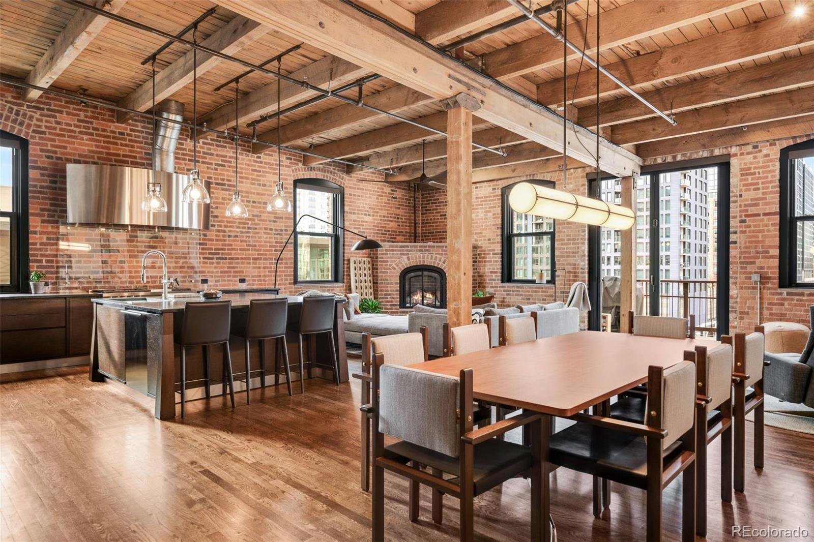 Experience penthouse living at its finest in Residence 516, a corner penthouse at the historic Ice House Lofts — a rare offering in the heart of LoDo. Built in the late 1890s, the Ice House blends its storied past with modern luxury. Exposed brick, timber accents, soaring ceilings, and abundant natural light define true Denver loft living.

Fully remodeled and designed for effortless entertaining, this turn-key residence showcases a chef’s kitchen with state-of-the-art appliances, including a Sub-Zero refrigerator, wine and beverage coolers, a Miele coffee station, a Wolf 6-burner range, double ovens, warming drawer, and an expansive island ideal for hosting. The open layout flows into a living area centered by a gas fireplace and enhanced with NanaWall doors opening to a serene balcony with unobstructed Union Station views — an unforgettable backdrop. Sofa and custom rug in the living room are included.

A thoughtful floor plan offers full-height bedroom walls, delivering modern privacy while preserving the Ice House’s historic character. Automated sound, lighting, and custom window coverings provide convenience. The secondary bedroom is a cozy entertainment lounge but easily converts into an office or guest suite. The sophisticated primary suite features a spa-inspired bath with an air tub, steam shower, and rain shower fixture. Built-out storage enhances every closet.

This penthouse includes two underground secured parking spaces, a private storage unit, and direct access to the building’s fitness center — an exceptional amenity package.

In the most coveted pocket of LoDo, residents enjoy access to Union Station, world-class dining, shopping, arts, entertainment, and Denver’s vibrant urban pulse. Penthouse 516 at The Ice House Lofts epitomizes historic charm, modern luxury, and unmatched location — an entertainer’s dream in one of downtown Denver’s most iconic buildings.

Be sure to explore the virtual tour links for a stunning video and 3D tour.