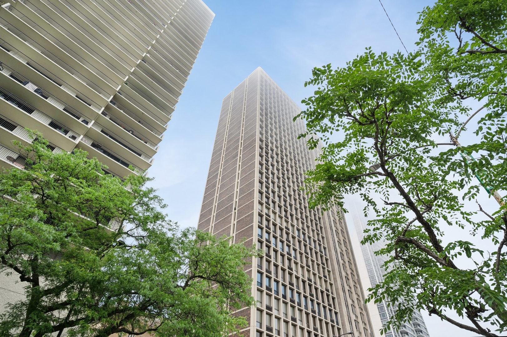 Perched on the 27th floor of a premier Gold Coast building, this 2-bedroom, 2-bath residence offers approximately 38 feet of light-filled unobstructed views of Lake Michigan. With hardwood floors throughout and generously sized rooms, living space and sweeping, doors and trim, the home blends timeless elegance with a fresh, updated feel-neutral paint tones, a crisp aesthetic, and move-in ready condition create a welcoming atmosphere. The open kitchen offers a great deal of countertop space and storage as well as bar seating. From the bedrooms you will enjoy sunset lighting and city views especially from this high floor. In unit washer dryer adds to the convenience of living here. The building's rooftop deck is a standout feature, complete with patio tables, grills, and breathtaking 360-degree views of the lake and skyline-perfect for entertaining or unwinding above it all. The building also offers 24 hour security and an exercise room. An ideal city retreat in a location that offers the best of Chicago's lakefront living within walking distance to world class restaurants and shopping.