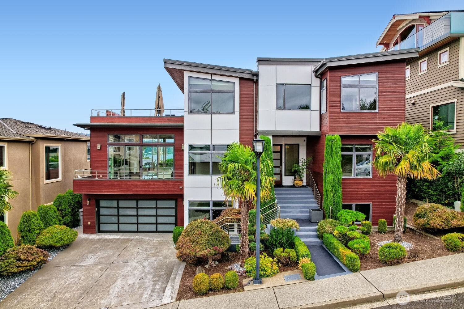 Custom-built home in coveted Lower Kennydale, just one block from Lake Washington, this exceptional 6-bed, 5.5-bath home offers 5,120 sq ft, panoramic views of Lake WA & the Bellevue skyline, and a private elevator serving all three levels. Inside, the heated entry floor leads to a versatile floor plan with multiple living spaces and room to spread out. Brazilian cherry hardwood floors and walk-in closets in every bedroom add thoughtful touches throughout. The lower level offers a private living space with a full kitchen, spacious living area, two bedrooms, a full bath, & laundry. On the main level, the chef’s kitchen features high-end Miele stainless steel appliances & centers around an oversized waterfall island with seating for five, while windows above the sink frame Lake WA views. The living room features exposed beams, a beautiful wood ceiling, & access to patios on both sides. A gorgeous dining room with tray ceiling, additional bedroom, bath, & powder room complete the main level. Upstairs, the spacious primary suite features a spa-inspired en-suite bath, along with two additional bedrooms, each with its own en-suite bath, and a laundry room. Step onto the third-floor deck to take in the panoramic views. Just minutes from Kennydale Beach Park, the Eastside Rail Corridor walking & biking path, I-405, DT Bellevue, & Seattle. A truly exceptional home where luxury & location come together!
