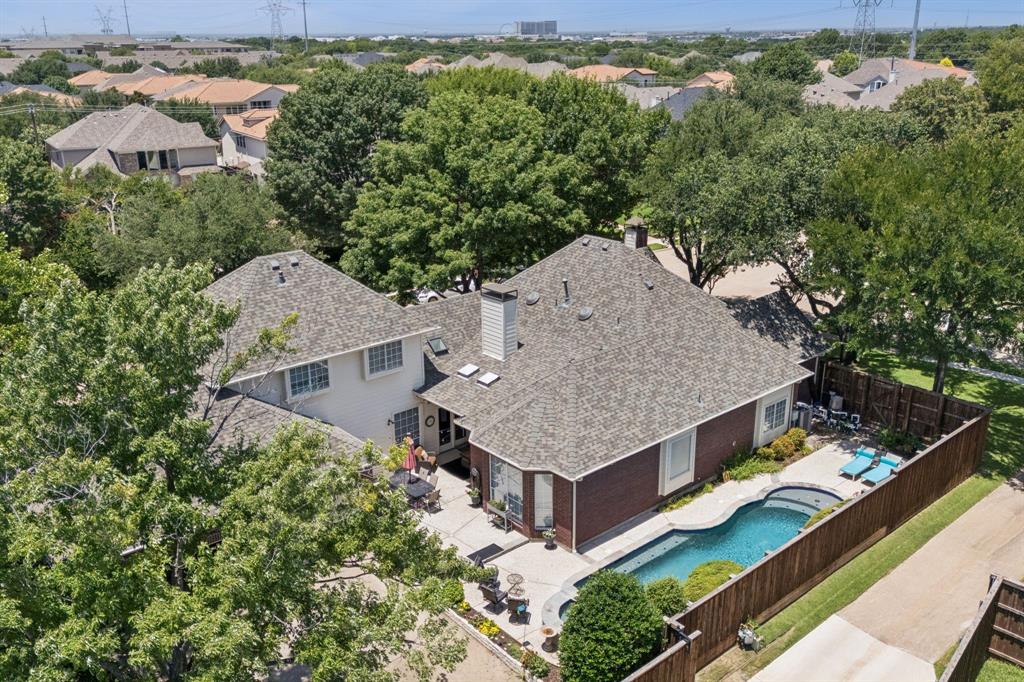 Welcome to your perfect West Plano retreat! Situated on a spacious corner lot, this thoughtfully designed home offers plenty of room to spread out, relax, and connect. Ideal for multi-generational living or hosting long-term guests, it features a separate living area with a large secondary primary suite—easily accessed separately from main living areas from the oversized 3.5-car garage. The large upper level primary bedroom could also serve as a gameroom, media or flex room. You will find another primary suite on the lower level along with a study, two additional living areas with fireplaces and two secondary bedrooms. 
The kitchen is ready for gatherings, boasting granite countertops, double ovens, a gas range, and a tumbled marble backsplash. Plentiful natural light creating a cheerful and welcoming atmosphere.
Step outside to a backyard built for fun and relaxation with a pool, spa and gathering space! Pool renovation completed in 2022 includes resurfacing, new heater, lights and app-controlled pump.  A new fence was installed in 2021.  Motorized gate provides access directly to driveway and garage area. New Roof 2024
From everyday comfort to space for everyone, this gem checks all the boxes.