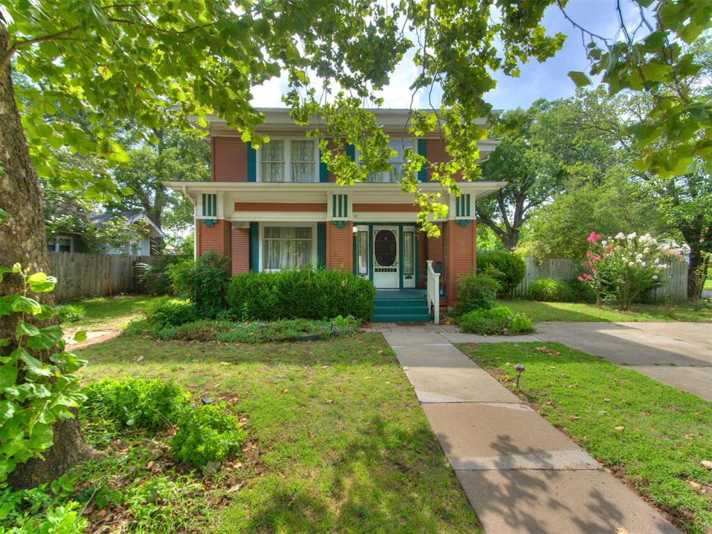 Walk to campus and downtown arts district from this CHARMING, HISTORIC  two story Prairie style home in Miller Historic District.   Hardwood floors. MAIN LEVEL : Formal Living and Dining, kitchen with gas built stove, granite, dishwasher, dining, sitting area with original fireplace, opens to deck with private garden.UPSTAIRS : 3 Bedrooms, plus Full bath and kitchen (which could be another bedroom) Possible Mother-in -law suite. driveway on both sides  of the front entrance. May be possible to add covered parking or garage on South side.  Some exterior changes would require permit from City Historic District Commission.