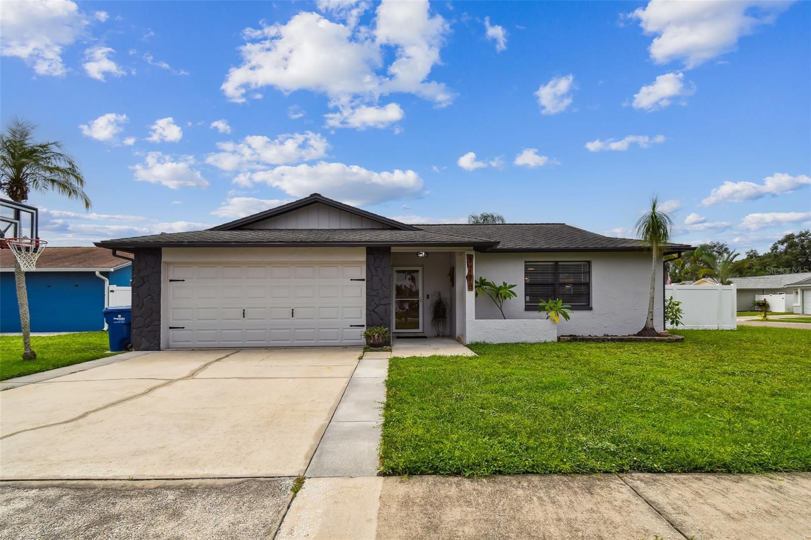 What you've been looking for! Location, Condition, Value- an excellent residence in the sought-after Blue Water Cove community. This three bedroom, two bath corner lot home has been lovingly updated and has spacious outdoor spaces for relaxing and entertaining. Location is an easy drive to the sparkling sands of the Gulf beaches, Tampa, shopping and dining. Walk to the canal and drop in a hook and try your luck or pull your boat out from the backyard covered storage and head to Gulf. Your open kitchen, with breakfast bar has French door refrigerator, range, microwave and dishwasher. Washer and dryer are just steps away in the garage. There was no flooding issues here with the 2024 storms and no HOA fees.