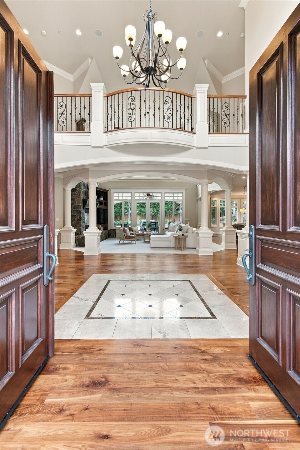 The entry opens to a grand two-story foyer.