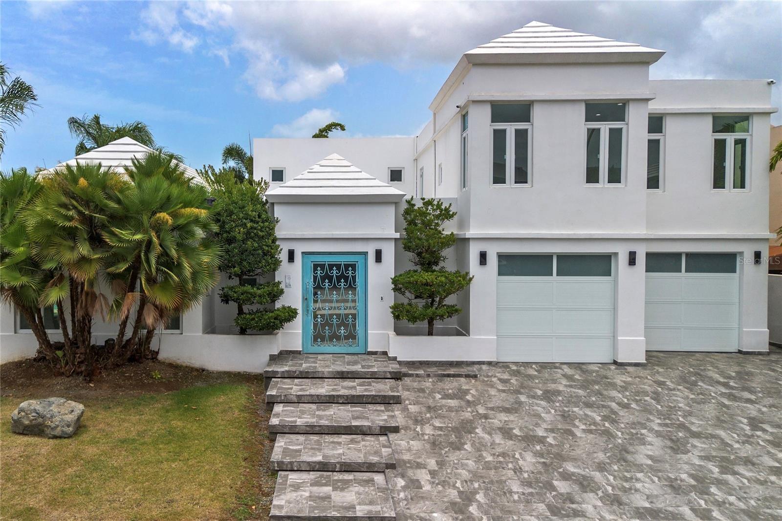 Located in the exclusive Paseo Las Palmas community of Dorado, this exceptional residence offers 4 bedrooms, 4.5 bathrooms, and approximately 4,200 square feet of thoughtfully designed living space on a 998.91 square meter lot. Designed for seamless indoor-outdoor living, the home features expansive floor-to-ceiling glass doors that effortlessly connect the elegant interior to a private outdoor retreat with a lap pool, spacious poolside terrace, and covered gazebo, creating an ideal setting for entertaining and everyday enjoyment. The light-filled open-concept layout showcases polished tile flooring, custom tray ceilings, and a gourmet chef's kitchen appointed with a large center island, premium stainless steel appliances, and refined stone countertops. A detached guest house significantly enhances the property's versatility, offering the perfect space for extended family, visiting guests, a private home office, a fitness studio, or independent living accommodations. Combining privacy, flexibility, and functional design, this additional structure adds meaningful long-term value to the property. Conveniently located just minutes from renowned schools, world-class golf courses, pristine beaches, fine dining, and everyday conveniences, this move-in-ready residence presents an outstanding opportunity to enjoy the Dorado lifestyle. CRIM: $6,796.49 annually.