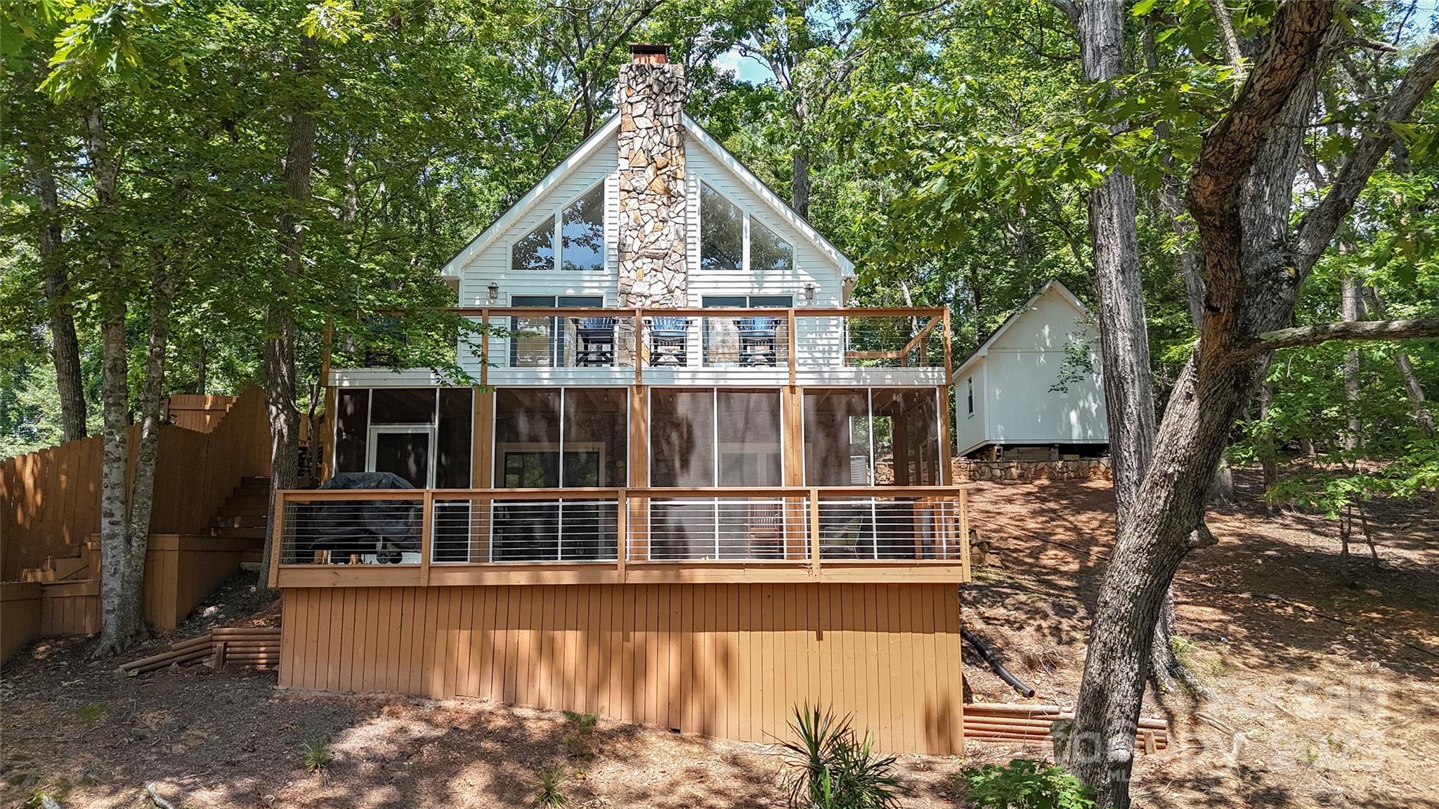 Your cozy Lake Tillery cottage getaway is waiting on you! Classic A-frame sitting in a quiet cove with water depth of 15 feet. This home boasts ample outdoor entertaining space and multiple decks, a screened in porch and grandfathered upper deck on the large 1200sqft dock featuring a TPO roof. A grandfathered in-ground boathouse for water toys and life jacket storage. New steps, decking and screened in porch with TPO covered deck on the home. When you're not boating you can jump off the upper deck, swing from your own rope swing, hang out on the deck or relax in the screened porch area. Open kitchen and living room area with a large loft space overlooking the downstairs that would make for a great game room or office! Storage shed is wired and has lots of potential. The home has had a new roof installed, new flooring and new HVAC system all in the last few years.