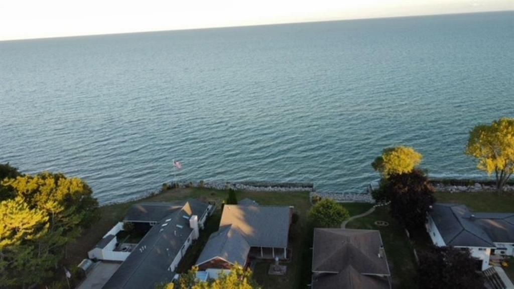"Beautiful Brick Ranch in the Sought-After Tawas Point Area" Located in the highly desired Tawas Point Beach area, this stunning 3-bedroom, 2-bath brick ranch offers main-floor living on a quiet dead-end street along the shores of Lake Huron. The open-concept layout features high ceilings, rich hardwood floors, and expansive floor-to-ceiling windows that showcase the ever-changing, breathtaking views of Lake Huron. The spacious main-floor primary suite includes a private bath and a generous walk-in closet. A flat lot provides easy access and outdoor enjoyment, while the 2-car garage offers ample storage. With minimal traffic and just a short bike ride to the sandy shores of Tawas Point Beach, this home is the perfect blend of comfort, privacy, and lakeside living.