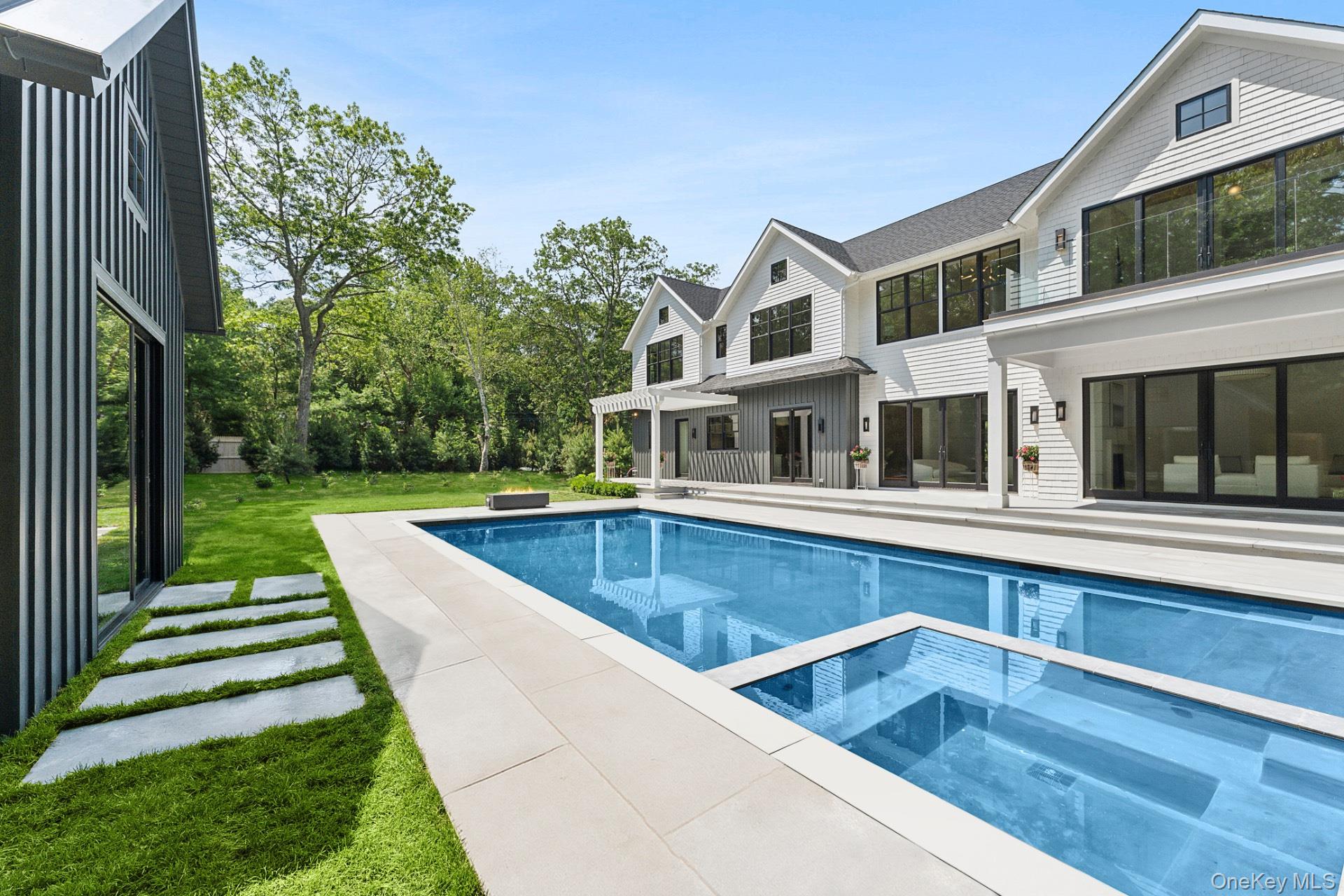 Nestled in the heart of Sag Harbor, this stunning 6,631sq. ft new construction home is situated on .52 acres moments from Sag Harbor Village. Boasting 6 bedrooms and 8.2 bathrooms, the thoughtful layout coupled with high end finishes and amenities creates the perfect haven for entertaining and enjoying all season long from the spacious double height foyer, sun-filled great room with floor-to-ceiling, custom chef's kitchen with oversized island, butlers pantry, formal dining room, first floor junior primary and office. Ascending to the second level, the primary bedroom beckons with a fireplace, private balcony, sitting room, and a spa-like primary bathroom with soaking tub and dual sinks. Three additional bedrooms, each with their own walk-in closet and bathroom, offer unparalleled comfort and privacy married by a sitting room for all to enjoy. The expansive lower level was designed with wellness and entertainment in mind, featuring a gym, sauna, temperature-controlled wine cellar, large recreational area with wet bar, media room, and additional ensuite bedroom with full bathrooms. Outdoors, the estate presents an exquisite retreat with an 40'x20' pool and 256+/- sq. ft. pool house, professional landscaping, and expansive porcelain patios for dining and lounging, offering the ultimate in outdoor and outdoor entertainment.