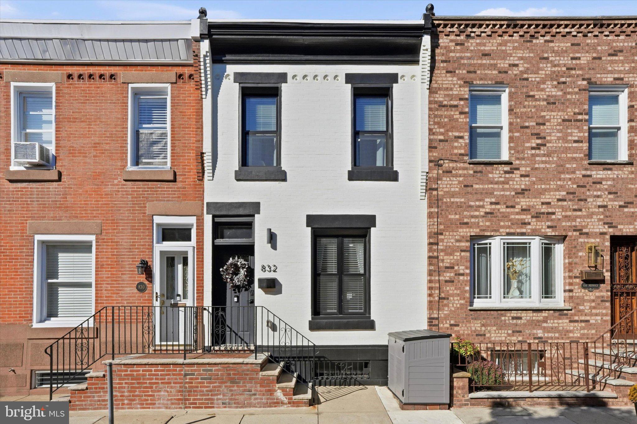 Located on a beautiful street in Fairmount, this two-story brick row home was completely renovated in 2023 with thoughtful finishes, custom woodwork, and lovely lighting throughout. The main level welcomes you with an open layout, engineered white oak flooring, tall ceilings, shadow box wall trim, updated sconces, and exposed brick that adds character and warmth. The living room flows seamlessly into the dining area and renovated kitchen, featuring white Calacatta quartz countertops, a glazed tile backsplash, a custom stucco vent hood, white Café appliances, and a white undermount sink. The kitchen also provides access to the oversized  backyard and basement.Upstairs, the primary bedroom features an accent wall, modern lighting, a built-in desk or vanity, and two built-out closets. The updated primary bathroom offers a spacious walk-in shower, penny tile flooring, and a Black Marquina quartz double vanity. A second bedroom and an additional full hall bathroom with a tub and shower complete this level.The fully finished basement provides additional living space, perfect for a second lounge, home office, or recreation area, along with convenient laundry. Outside, enjoy a partially covered back patio with privacy fencing, creating a comfortable spot to unwind or entertain.With a fantastic location, 832 Pennock St is just a few blocks from the Philadelphia Museum of Art and the many restaurants, cafés, and neighborhood shops along Fairmount Avenue. Enjoy easy access to Kelly Drive, the Schuylkill River Trail, and Fairmount Park, with even more museums, attractions, and Center City just a short trip away.Enjoy the best of Fairmount living with 8 years remaining on the 10-year tax abatement for added property tax savings.
