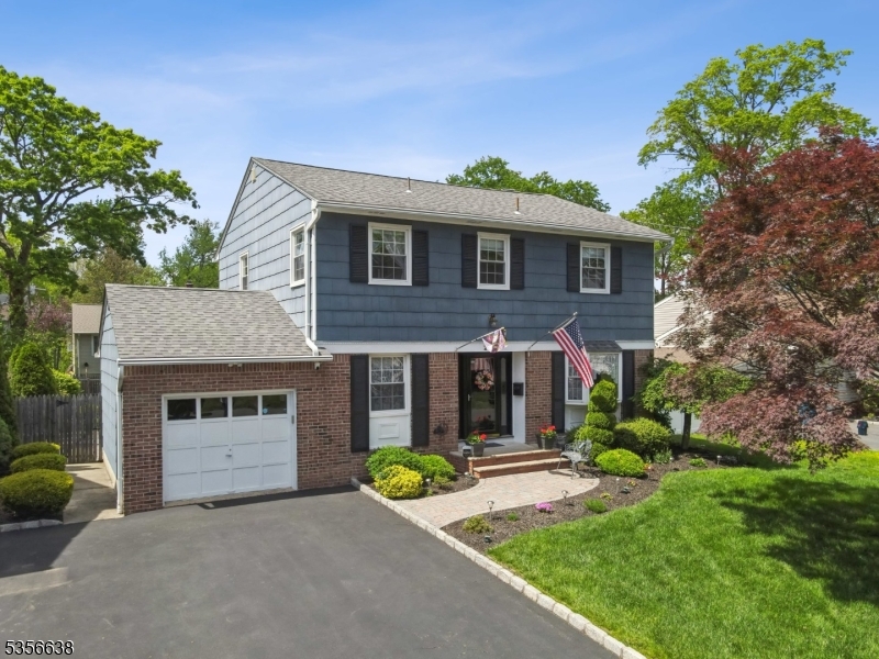 Well-maintained 4-bed, 2.5-bath center hall Colonial in a desirable neighborhood. The home features a paver walkway, landscaped front yard, and a bright, welcoming foyer. The spacious living room and formal dining room both offer hardwood floors and large windows. The updated eat-in kitchen includes recessed lighting, stainless steel appliances, quartz countertops, tile backsplash, and a garden window overlooking the fenced-in backyard. Off the kitchen is a cozy family room with hardwood floors, a wood-burning fireplace, and sliding doors to a large deck. The outdoor space features a deck, paver patio, and beautifully landscaped yard great for entertaining. Upstairs are four comfortable bedrooms, including a primary with an en suite bath. The finished basement offers flexible space with two separate areas ideal for a rec room, gym, office, or media space. Convenient to schools, parks, shopping, and major roads. A move-in ready home with timeless appeal!
