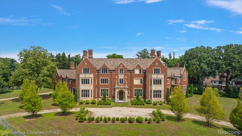 Welcome to the Bishop Mansion, one of Detroit’s most storied and iconic estates, located in the heart of historic Palmer Woods. Originally built in the 1920s for Bishop Michael J. Gallagher, this nearly 40,000 square foot Tudor Revival residence spans four full levels and sits on over two gated and private acres.
The carriage house and attached garage have been completely restored and renovated, offering a stunning example of what’s possible within the main home. Inside the main house, strategic demolition has been completed to allow for a full HVAC redesign, as well as updated plumbing and electrical systems. Architectural plans are included and ready for the next owner to bring this historic estate back to life. All back taxes have been paid.
Among the home’s remarkable original features is a private chapel with soaring ceilings, intricate stained glass, and carved stone detailing—one of the few residential chapels of its kind in the region. Additional features include multiple limestone fireplaces, grand woodwork, and dramatic formal spaces waiting to be revived.
Minutes from the Detroit Golf Club and Downtown Detroit, this is a rare opportunity to complete a legacy project that blends history, scale, and unmatched potential.