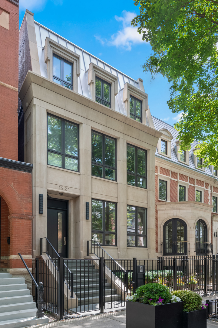 This meticulously updated limestone and brick residence spans four stories and over 5,122 square feet, offering an Extra-Wide floorplan with six bedrooms and 5.2 bathrooms, plus three incredible outdoor spaces, including a fully rebuilt penthouse-level rooftop retreat. Designed for the most discerning buyer, the home features an extra-wide floor plan with refined custom finishes, custom built-ins, tray and beam ceilings, wainscoting, detailed moldings, soaring ceilings, and a fully integrated automation system that elevates modern living. The light-filled living room and separate dining room are thoughtfully designed with an open layout, complemented by a formal entry and framed by views of the tree-lined street. The upgraded gourmet kitchen serves as the heart of the home, showcasing white cabinetry with integrated lighting, stone countertops with an oversized island, a coordinating backsplash, and a built-in banquette. Enhancements include dual wine refrigerators and a reverse osmosis water filtration system, alongside a full suite of premium appliances, including Wolf double convection ovens, a 48" professional range with griddle, built-in microwave drawer, Dacor hood, SubZero refrigerator and freezer, two Bosch dishwashers, and a beverage center. The family room opens seamlessly to the outdoor spaces, creating a natural flow between indoor and outdoor living. Entertain or unwind on the beautifully renovated, raised patio with cozy fireplace and meticulously landscaped garage rooftop, complete with an aluminum pergola, a gas fireplace with a clad chimney, and both a Lynx gas grill and a Blaze aluminum charcoal grill. Enjoy large-format tiled flooring, an insulated ice chest, custom maintenance-free aluminum louvered fencing, a built-in irrigation system, and layered accent lighting with uplighting. Outdoor living continues with the fully rebuilt penthouse-level rooftop retreat, featuring mahogany composite Azek decking, fiberglass planters, layered lighting, radiant heating beneath an aluminum-clad pergola to extend the entertaining season, metal screens, and integrated irrigation- all offering sweeping city views that epitomize urban luxury. The lower level features a spacious, light-filled family room with heated floors, a sixth bedroom currently used as an exercise room, and a full en-suite bedroom with abundant storage. Laundry facilities are conveniently located on both the second floor and lower level. The top floor features a private office and a fifth en-suite bedroom, providing flexible spaces for work and living. The home also offers a state-of-the-art infrastructure, including a snow-melt system for the front steps and garage walkway, a highly insulated roof designed by a LEED-certified architect, skylights with UV protection, and high-efficiency HVAC systems. Upgrades include two Carrier AC units, two Daikin DM97 modulating variable-speed furnaces with humidifiers, air scrubbers, purifiers, heat exchangers, and heat pumps, as well as an NTI TRX modulating boiler system with new zoning, pumps, air eliminator, and WiFi-enabled snow-melt controls. Additional improvements include a new ejector pump and water-powered sump pump. Situated in the heart of Lincoln Park, the home is just steps from Armitage's vibrant shopping and dining corridor, Oz Park, and Chicago's lakefront, placing the very best of city living at your doorstep.