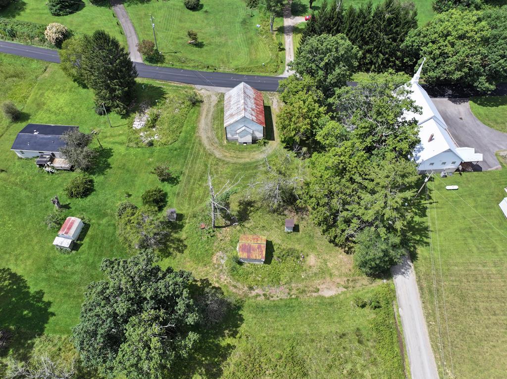 0.42 ac of land located at 3727 Conner Grove Road in Willis, Virginia. This level lot offers convenient frontage on a state-maintained paved road, ensuring easy access year-round. The property features the former Conners Grove Primitive Baptist Church, a character-filled structure that provides exciting possibilities. Whether you envision restoring it for community use, repurposing it into a studio, workshop, or gathering space, or starting fresh with a new build, the choice is yours. A drilled well is already on the property (not currently hooked up). There is no septic system in place, allowing you to design one tailored to your needs. This property is being sold as land only, with a structure on the land. 10 minutes to Meadows of Dan, VA and the Blue Ridge Parkway.  20 Minutes to Floyd, VA.  30 minutes to Hillsville, VA and Interstate I-77. 45 Minutes to Christiansburg, VA.