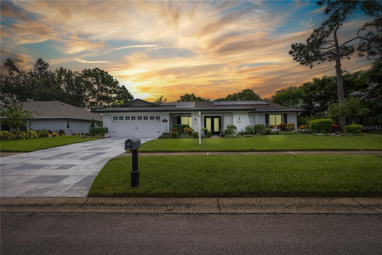 Your next home is ready for you!!  This beautifully updated 4-bedroom, 3-bath home offers one of the finest views on the 2nd fairway of Countryside Country Club’s Lake Course. Perched 99 feet above sea level in Flood Zone X, this home provides peace of mind along with stylish Florida living.

Enter through the elegant leaded-glass double doors to a bright, open floor plan featuring modern Hickory engineered wood floors throughout. The kitchen is a chef’s dream with a gas range, vented stainless hood, large center island with seating, and direct views of the family room and pool. The inviting family room includes a custom window seat, perfect for enjoying the golf course views or cozying up by the fireplace. A 2/2 split-bedroom layout ensures privacy for all.

This one is move-in ready!! Major updates have already been completed, including solar electric panels for ultra-low utility bills, on-demand hot water, whole-house water filtration, fresh exterior paint, new pool pump, modern vinyl and decorative metal fencing, and electrical upgrades with ground and surge protection. Additional improvements include attic insulation, driveway coating, outdoor lighting, new fixtures, and fans.
The screened pavered patio, PebbleTec-lined saltwater pool, and lush tropical landscaping create an ideal outdoor retreat with stately trees, a pet-friendly yard, and a charming gazebo for evenings by the fire pit. Panoramic golf course views complete this entertainer’s backdrop.

Centrally located and move-in-ready, this home is under 30 minutes from two International airports and two of America’s top-rated beaches, with shopping, dining, and entertainment nearby. A rare opportunity to enjoy comfort, convenience, and an incredible lifestyle in one of Clearwater’s most desirable settings.