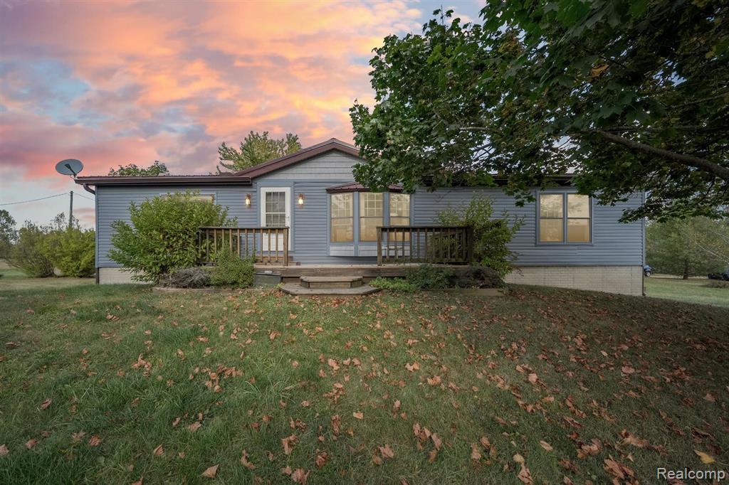 Great opportunity! This amazing home is situated on almost 5 acres with mature trees and has a park like setting.  Step inside and find an open floor plan with custom made kitchen cabinets, large pantry, stone tile counters & all kitchen appliances are included (washer and dryer too). The ceilings are vaulted with lots of natural light from skylights.  Stay warm with the woodstove in family room which can heat the entire home. Another nice upgrade is the maintenance free bamboo flooring. Outside you will find a newer steel roof on house & the garage plus newer siding on home. The full finished basement has 9’ ceilings with daylight windows for even more living space.  Entertain at the basement bar and eating area, which is a perfect area to have as a rec room.  There is also an additional room with a closet that could be made into a 4th bedroom.  Out front there is a nice size front deck, along with one off the dining area. The oversized garage is 30x40 and includes a concrete floor, electric, wood burner (not currently being used) and ample space for extra storage. There are several trees that create privacy from the road as well over 20 apple trees that line the side road.  Look out back and enjoy the deer and wildlife!  Imlay City school district.