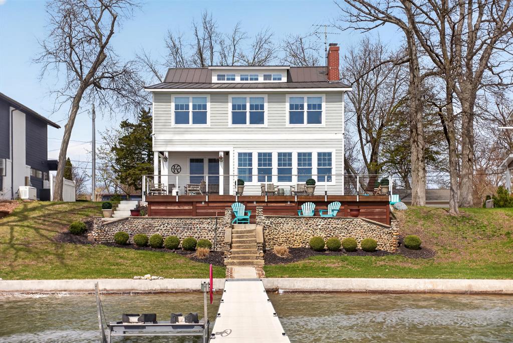 The Cherry of Cherry Point. Lady of the Lake exudes classic charm, rooted in her architectural bones, the best of her past has been honored, preserved and updated to provide every amenity for luxury lake living. The open floorplan is casually elegant, welcoming for a spirited gathering or a quiet weekend. Spectacular views from inside, covered and open decks look to 80' of sandy beach Devils Lake frontage. Offset by a private side patio. The 2nd floor hosts 3 bedrooms and 2 baths and the spacious primary ensuite. Up again there is a dormitory of dreams, designed for giggles, whispers and snores! Additional back lot with oversized garage, concrete seawall, lots of storage and memories for a lifetime.
